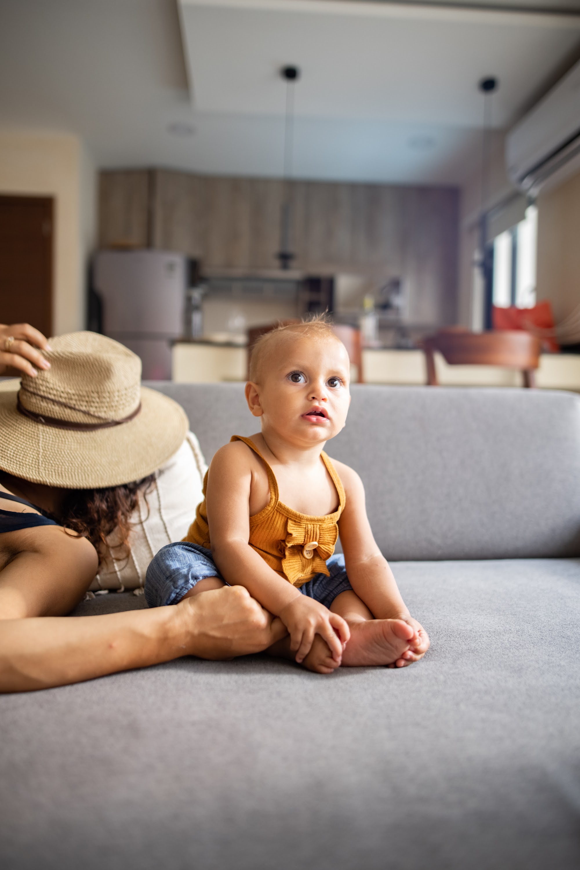 Baby Sitting on Couch with Parent