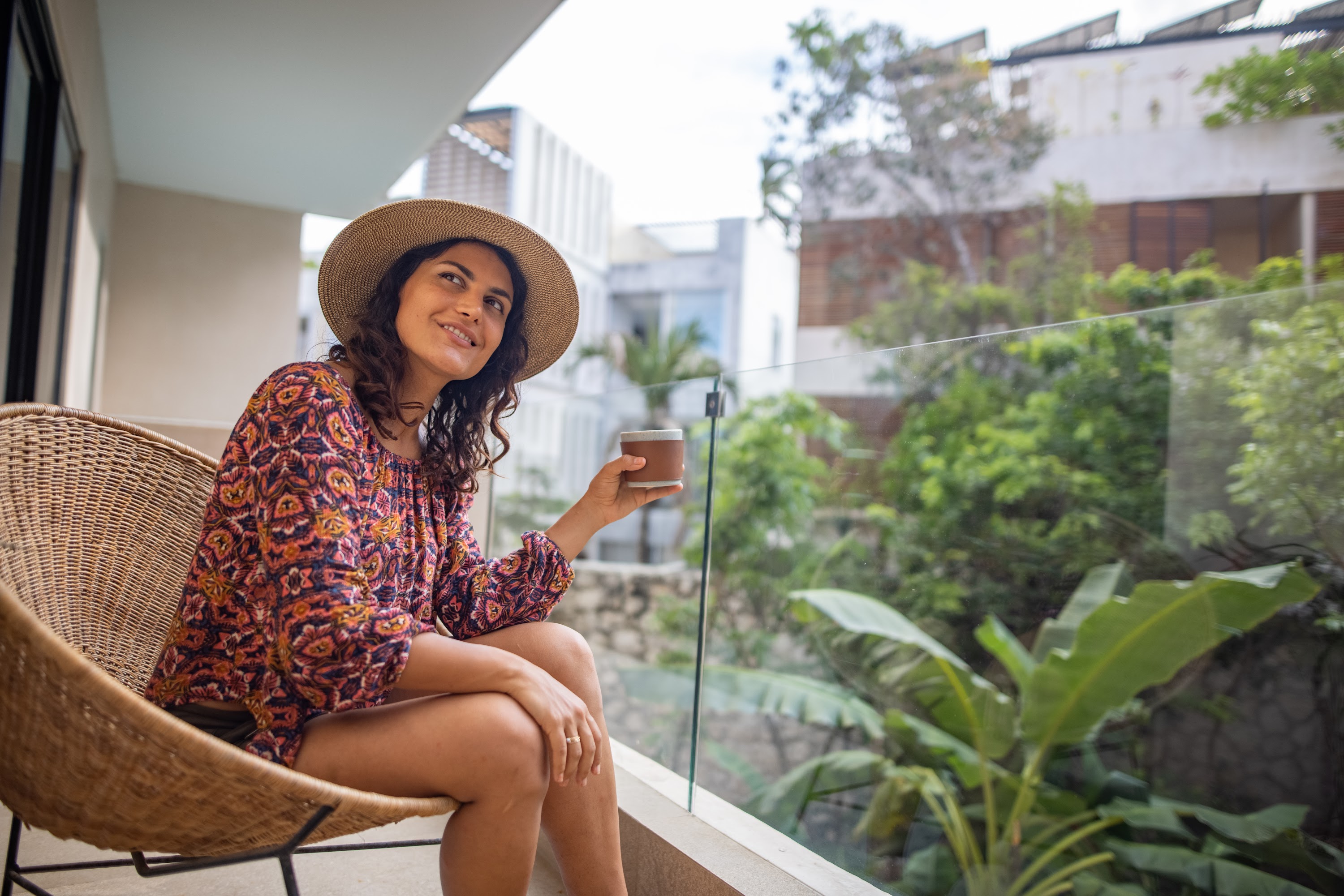 Woman Enjoying Coffee on Balcony