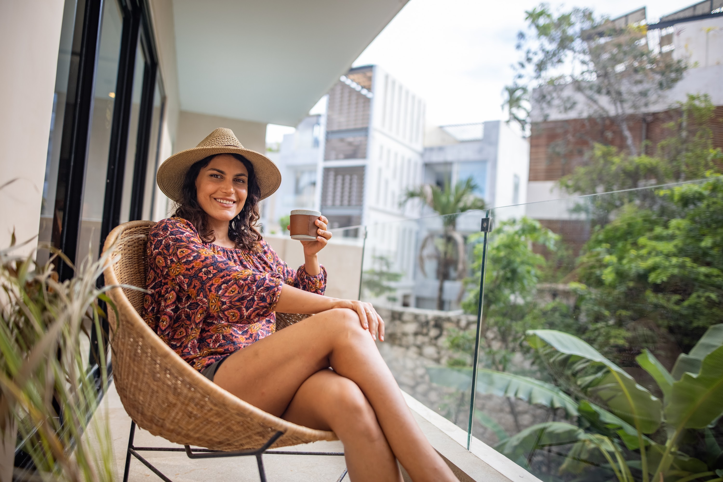 Woman Enjoying Coffee on Balcony