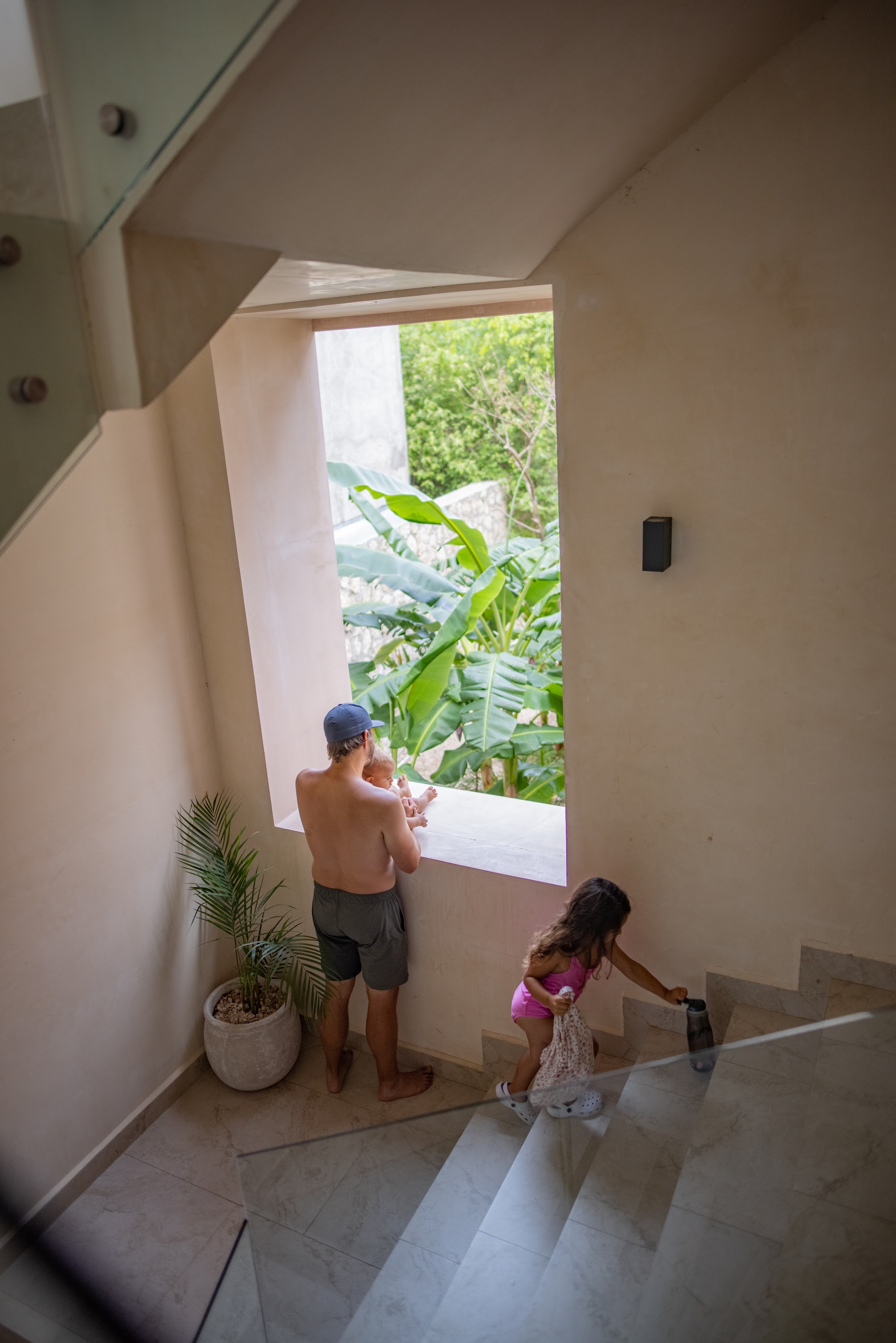 Family on Stairs Looking Out at Garden