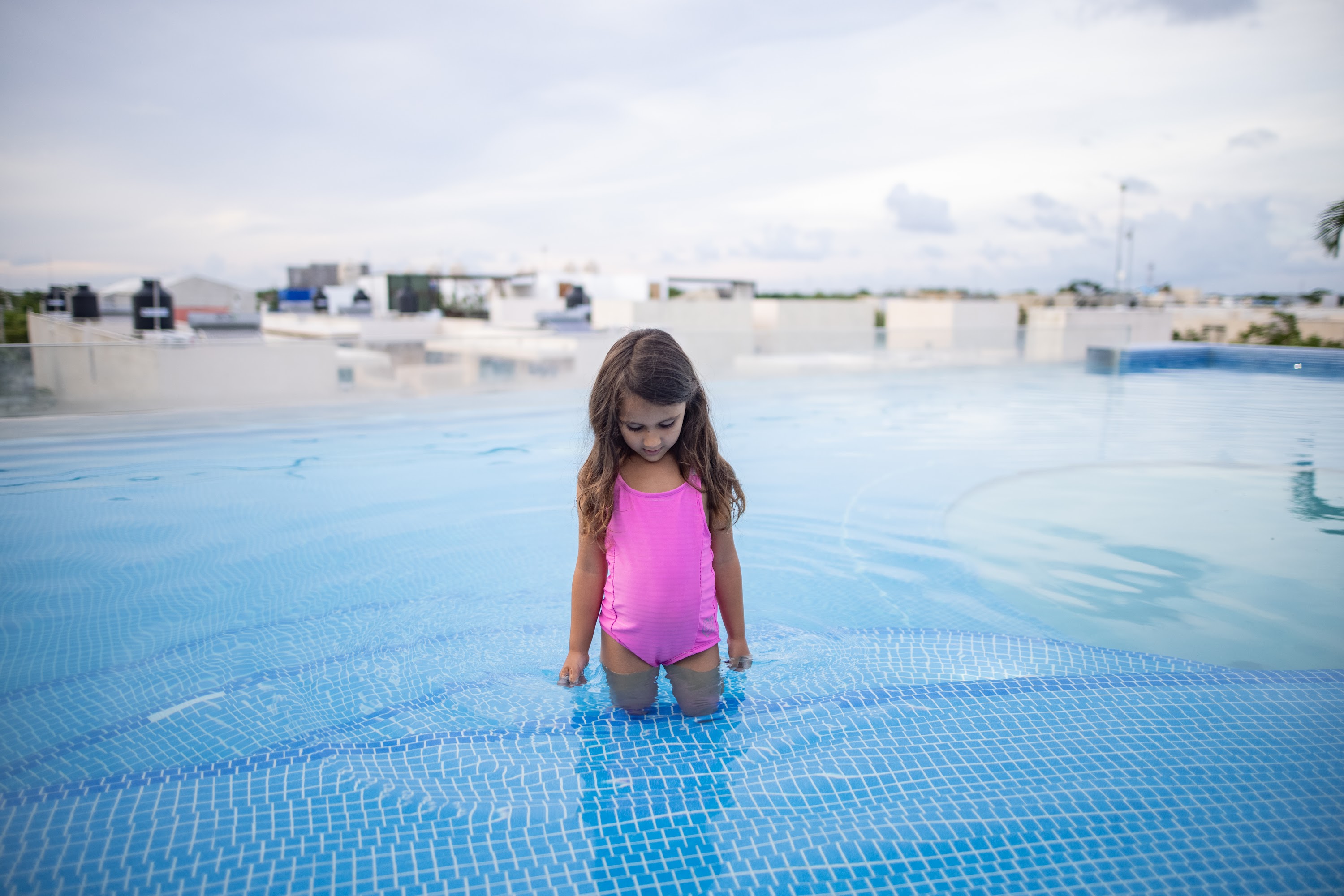 Young Girl in Pink Swimwear Standing in Pool