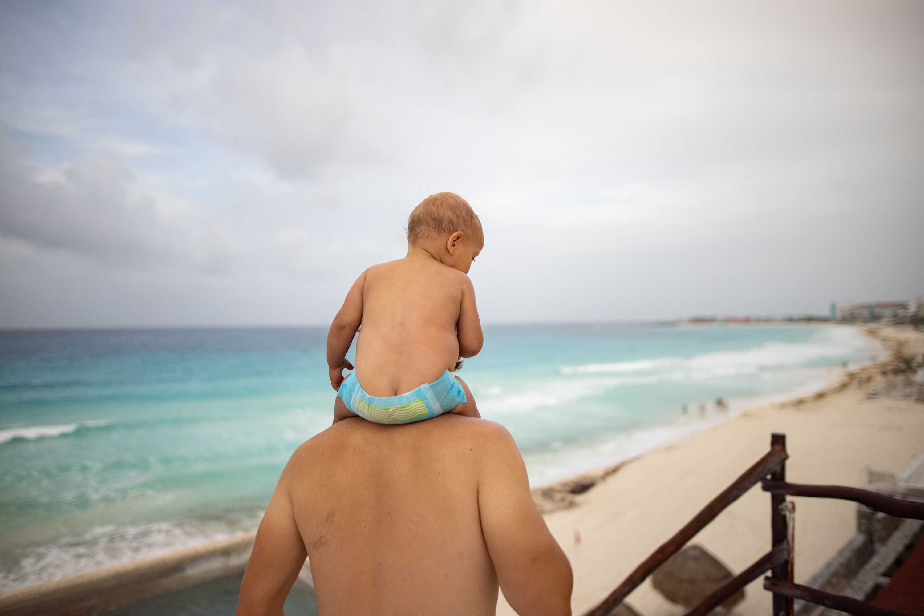 Father Holding Baby on Beach