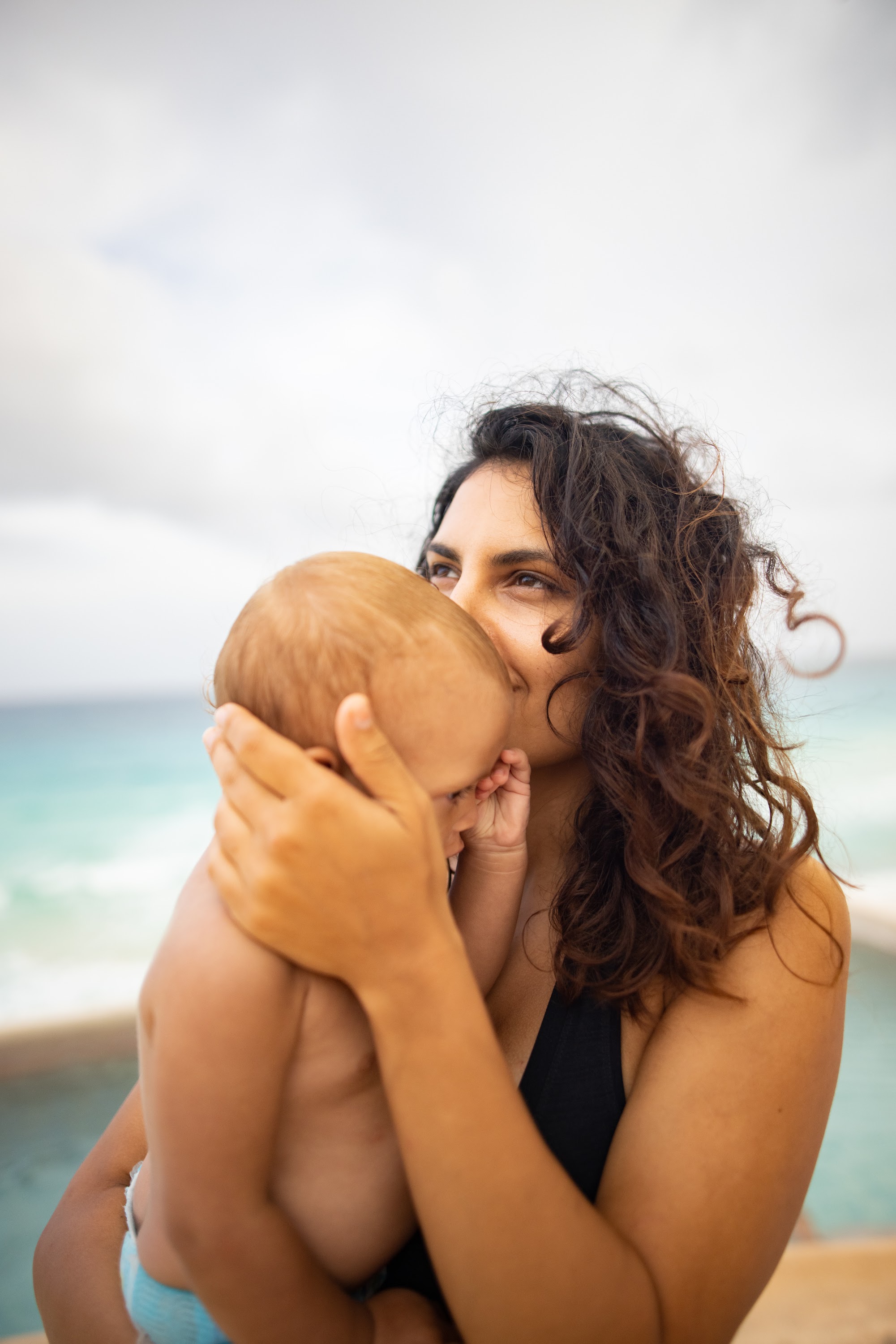 Mother Kisses Baby at the Beach