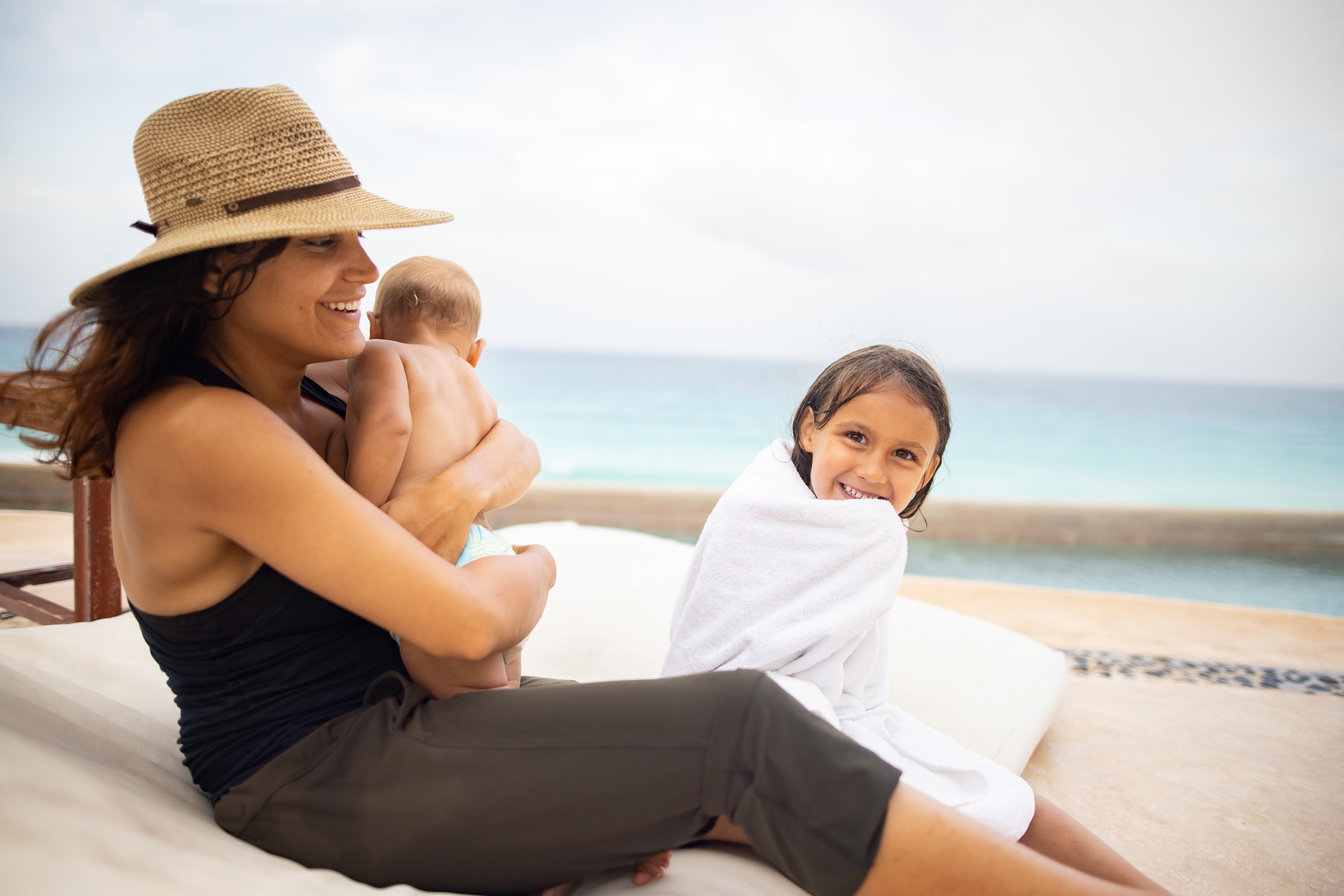 Mother and Children Relaxing by the Beach