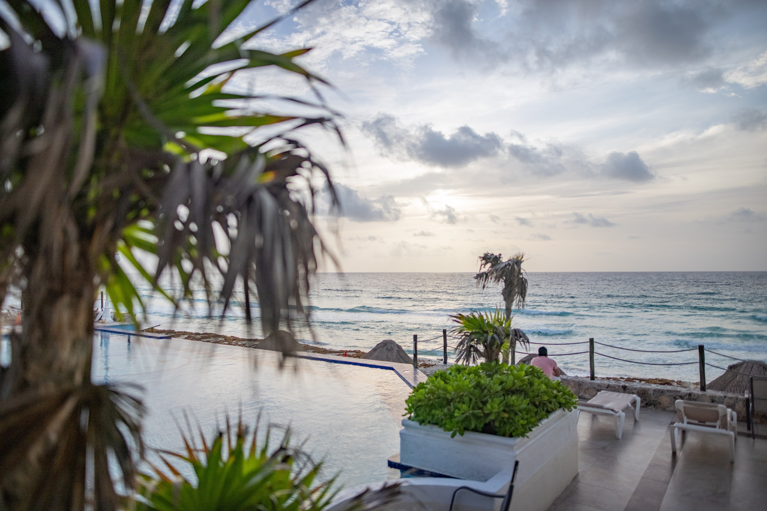Sunset by the Ocean with Pool and Palm Trees