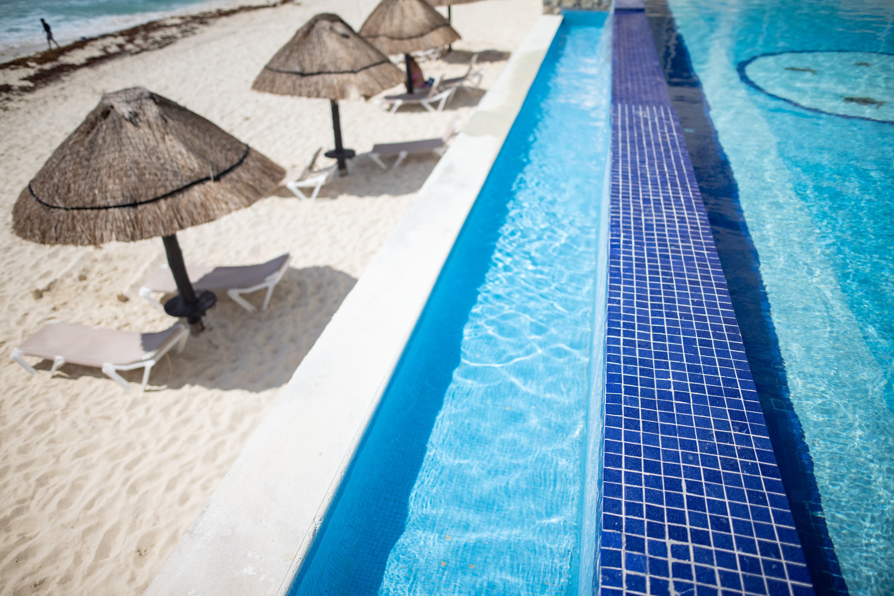 Beachside Pool with Thatched Umbrellas