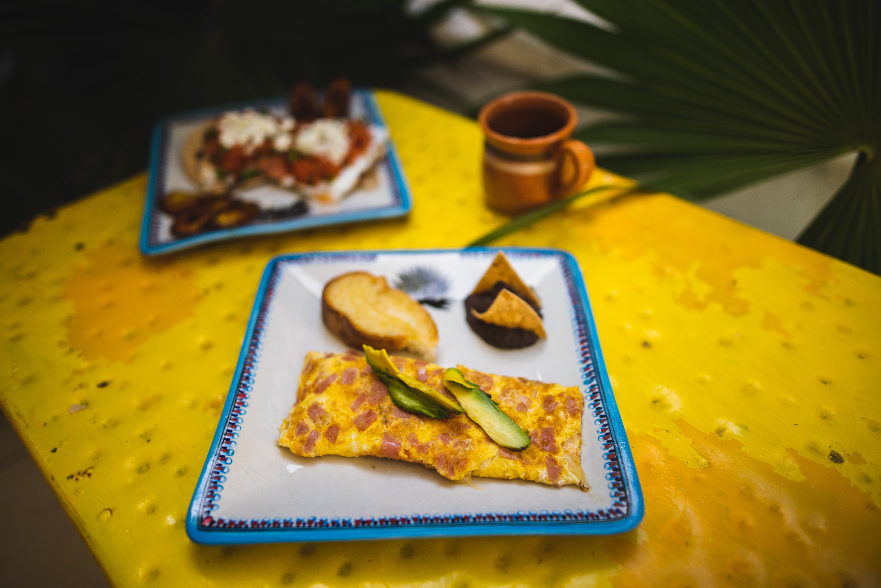Colorful Breakfast Plates on Vibrant Yellow Table