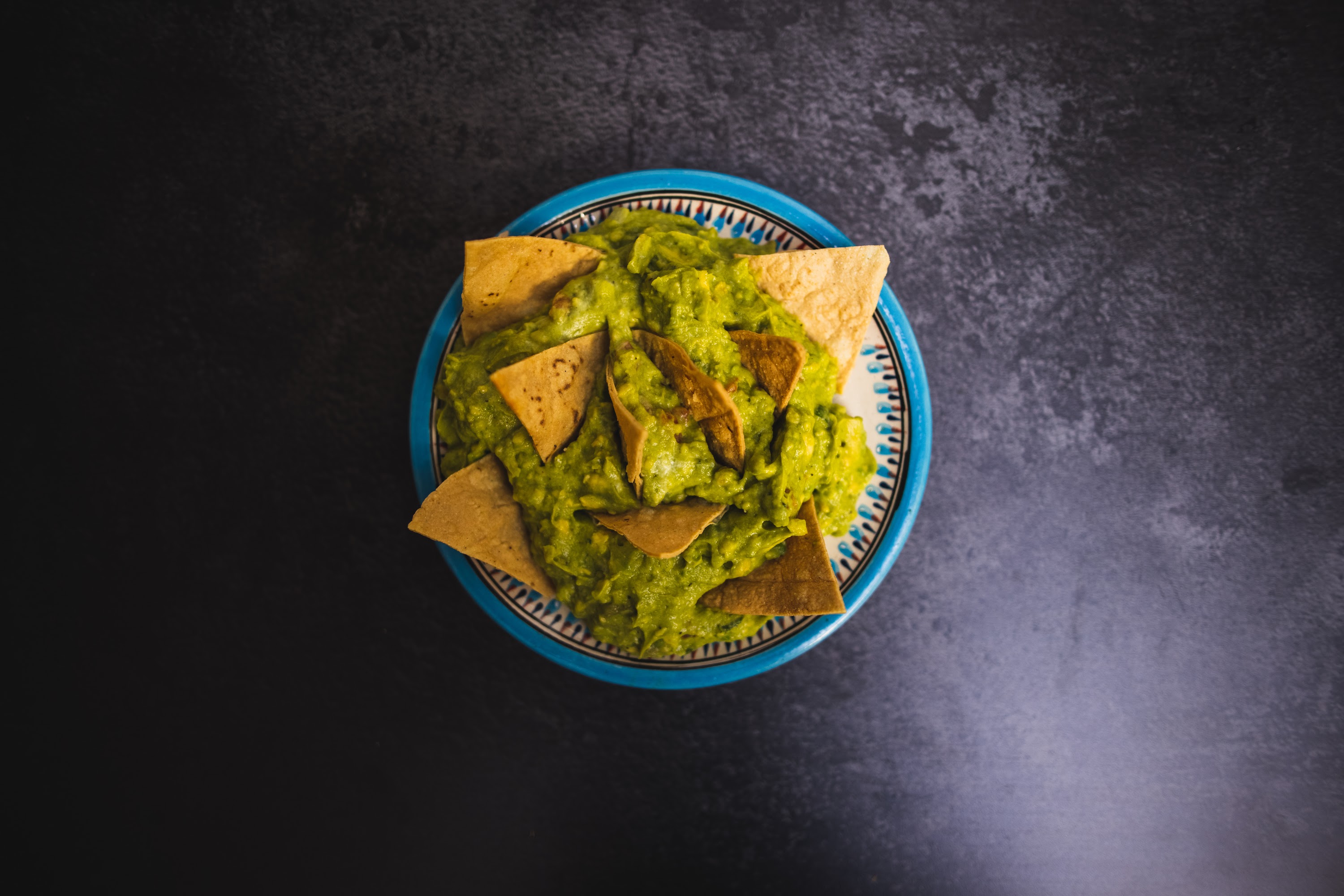 Guacamole with Tortilla Chips on a Blue Patterned Bowl
