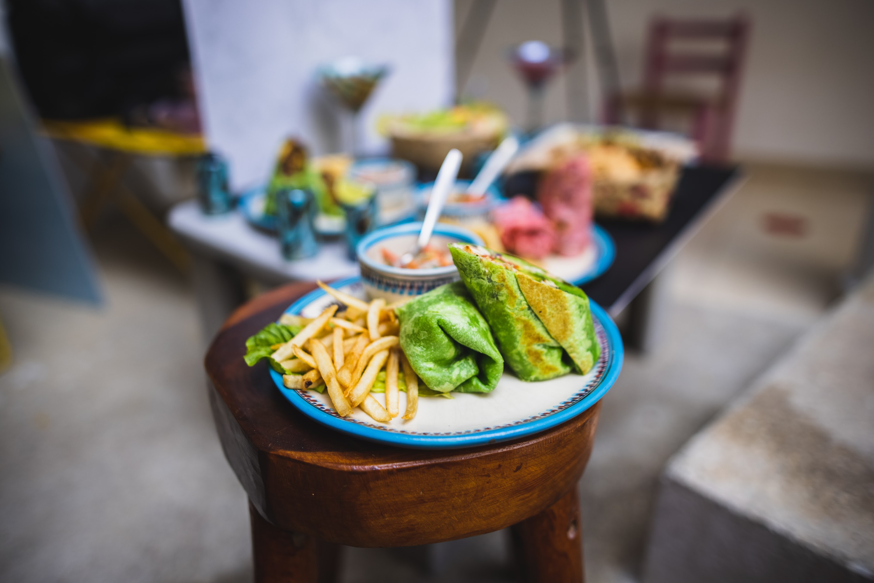 Colorful Wrap and Fries on Wooden Stool