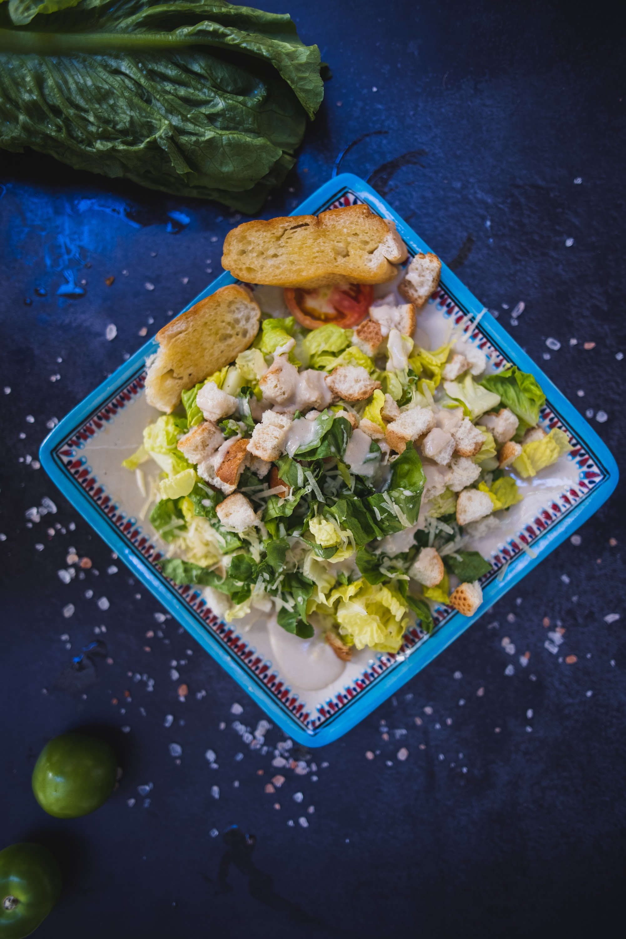 Overhead Flat-Lay of Caesar Salad on Dark Surface