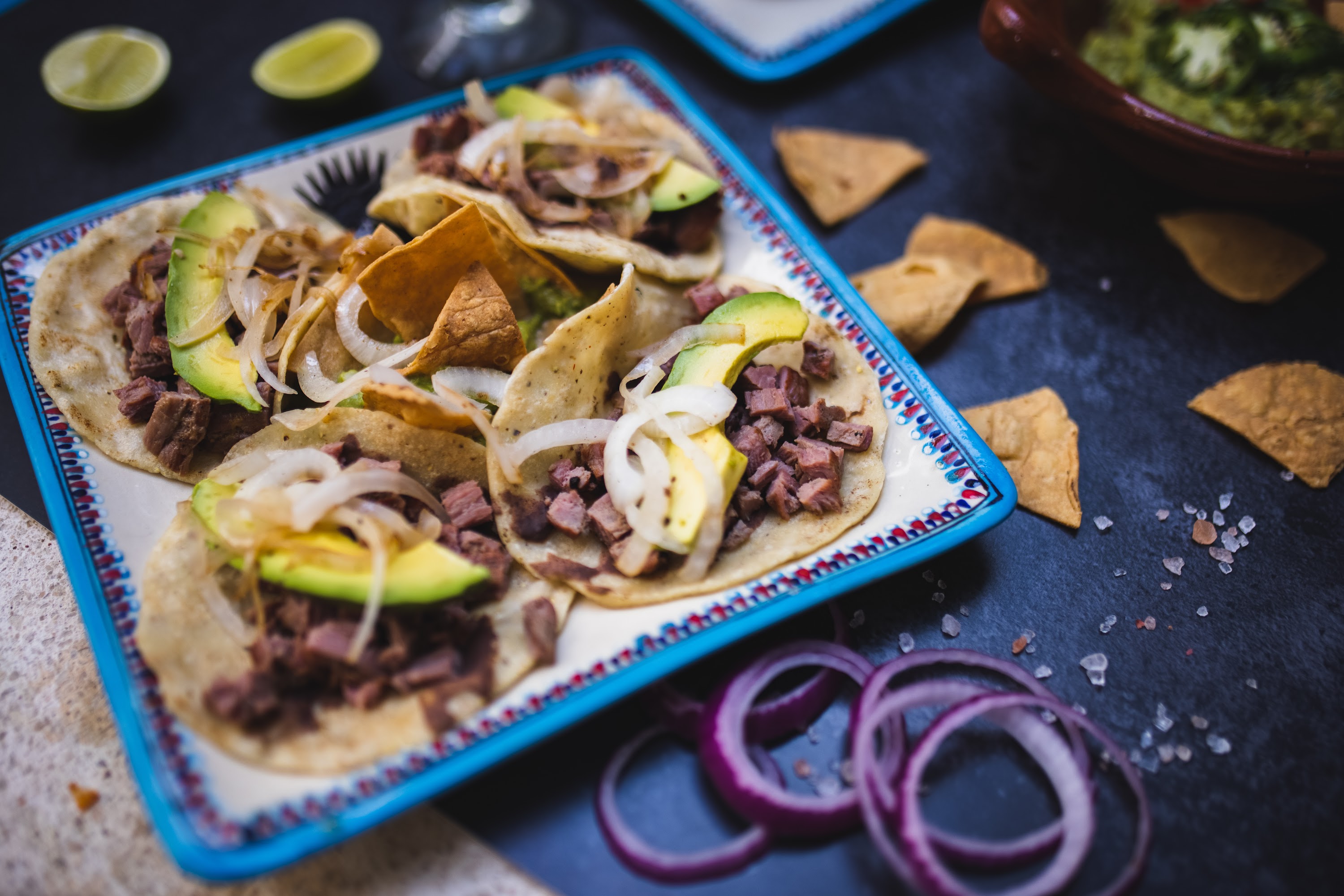 Tacos with Beef, Avocado, and Onions on a Decorative Plate