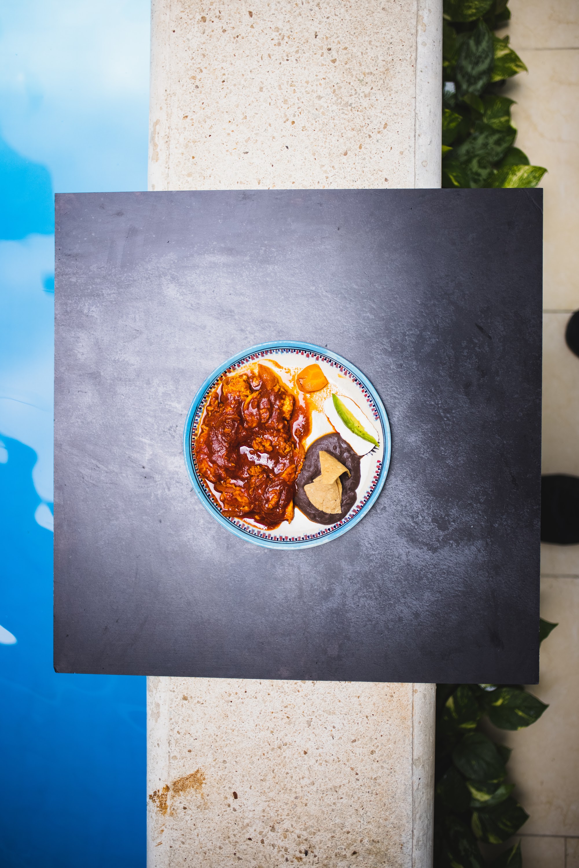 Top-down view of Mexican-style dish by poolside