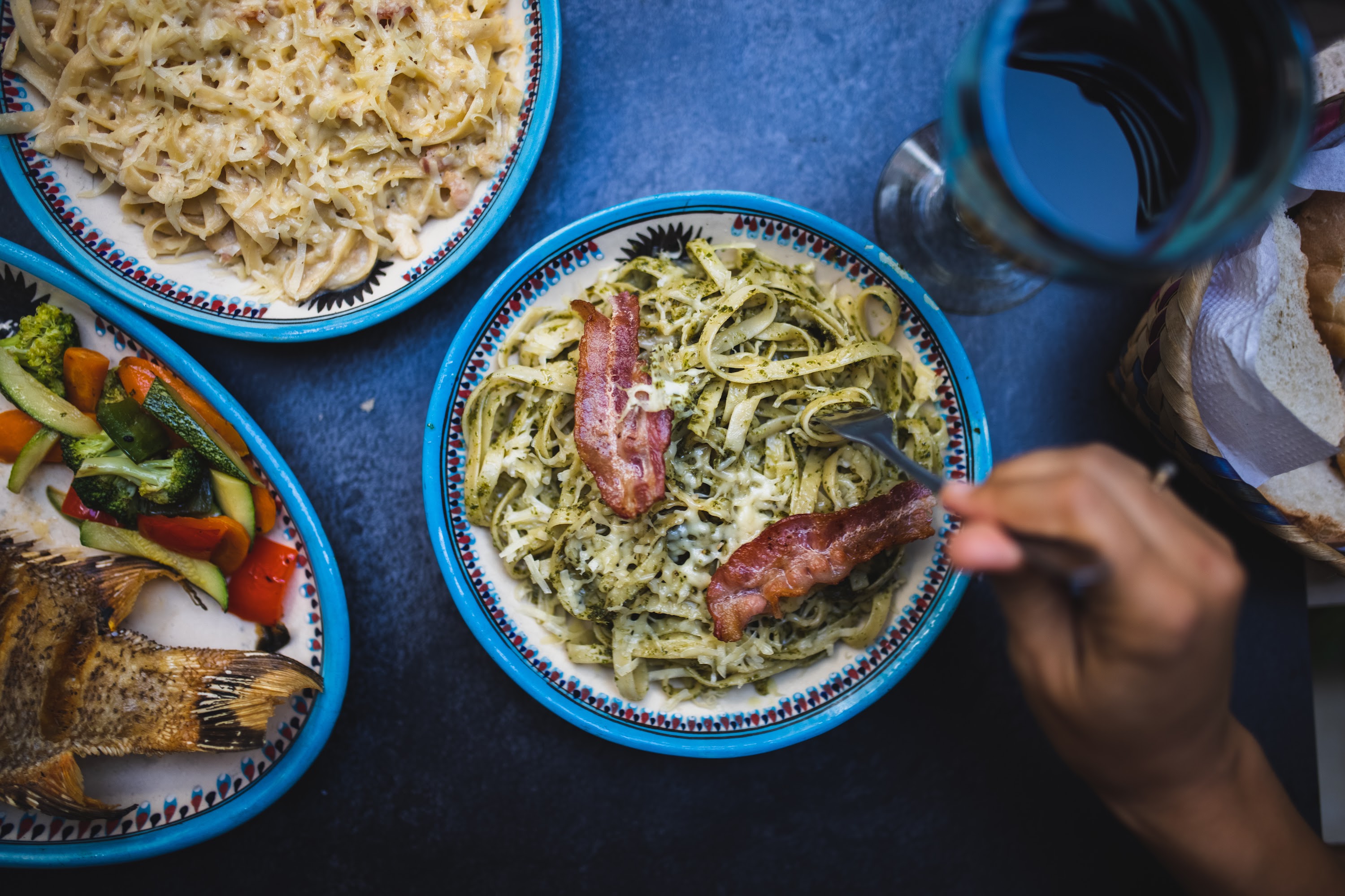 Plate of Pesto Pasta with Bacon and Side Dishes
