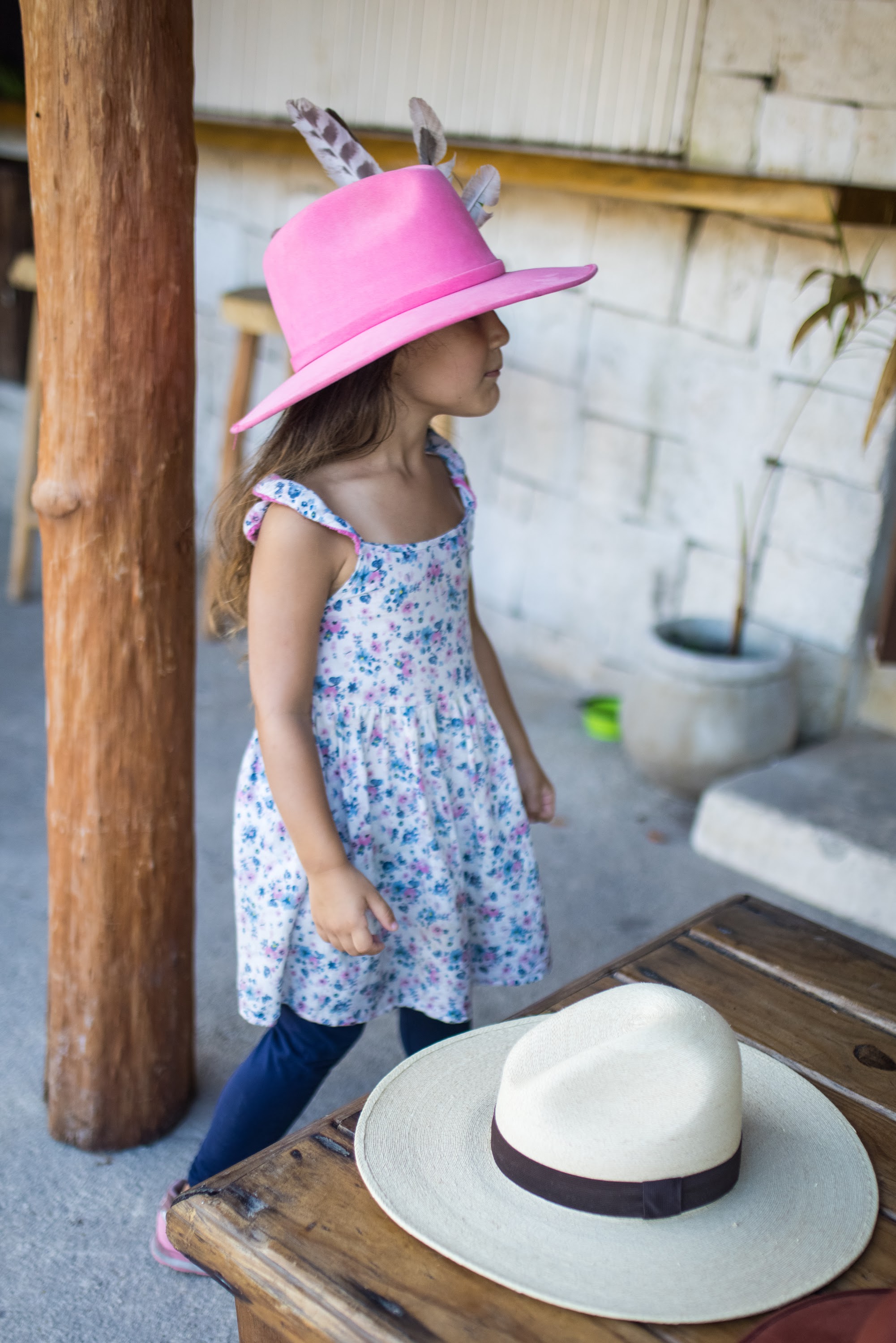 Girl in Pink Hat with Feathers Standing Outdoors