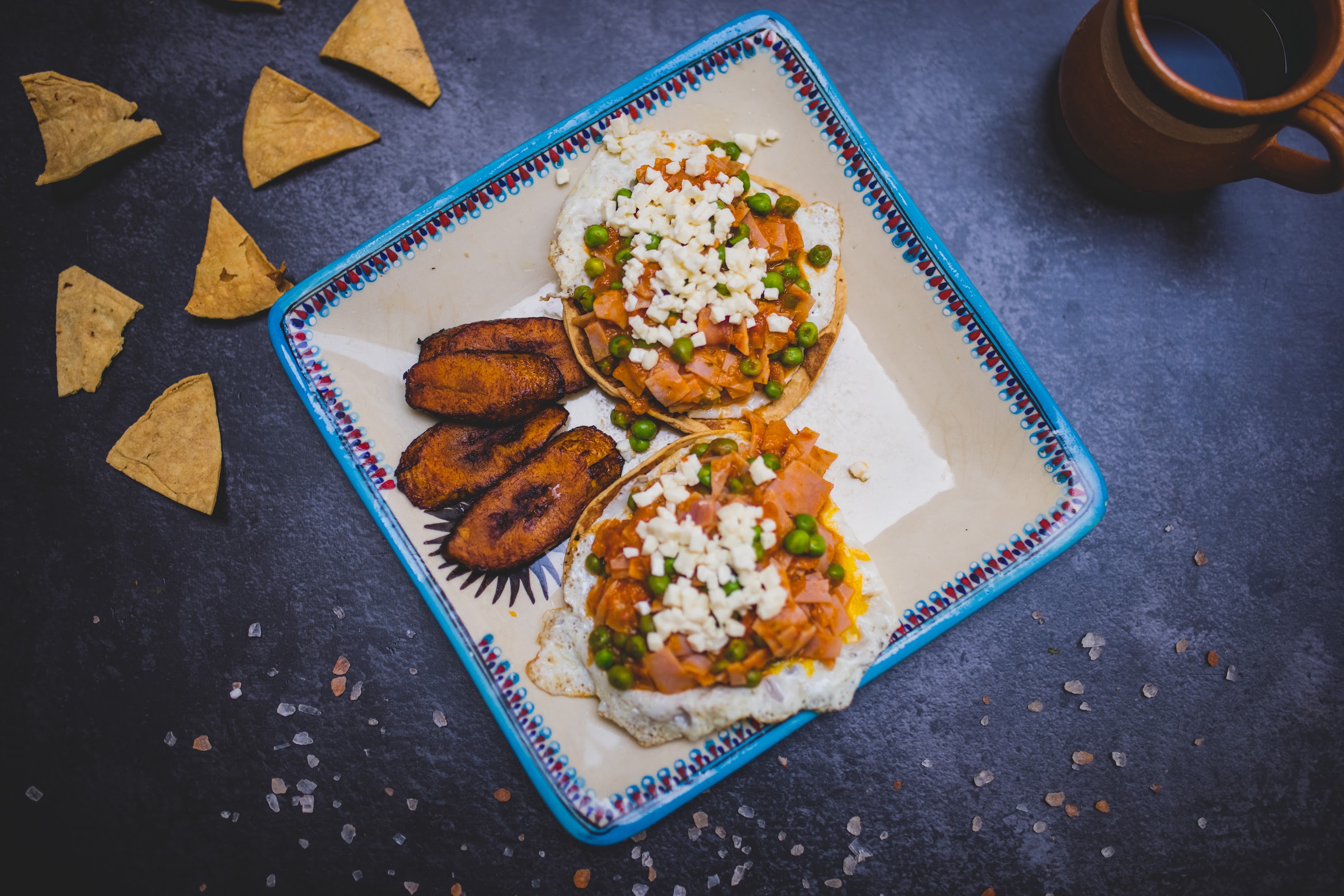 Mexican-style breakfast plate with huevos rancheros and plantain