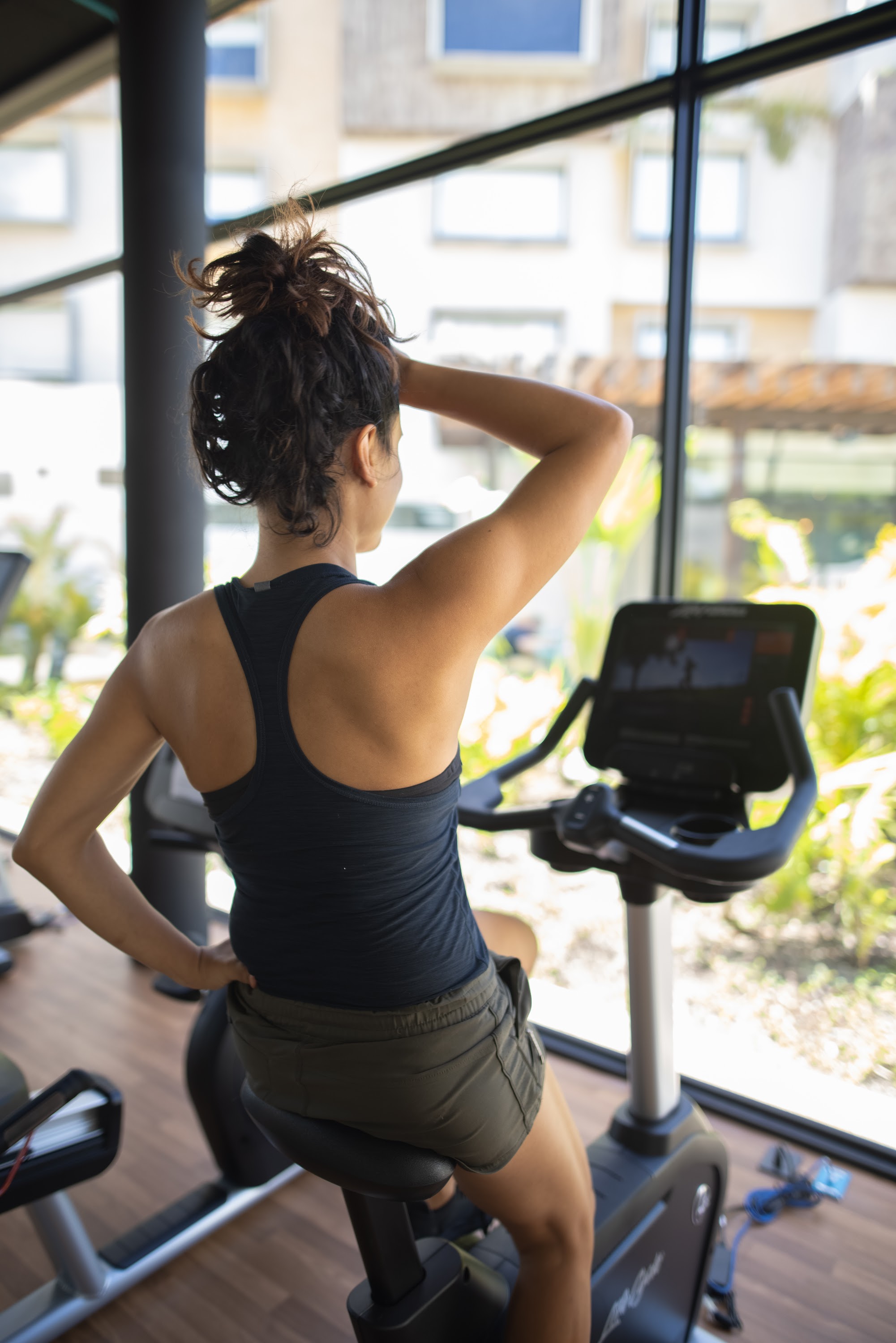 Woman Exercising on Stationary Bike in Gym
