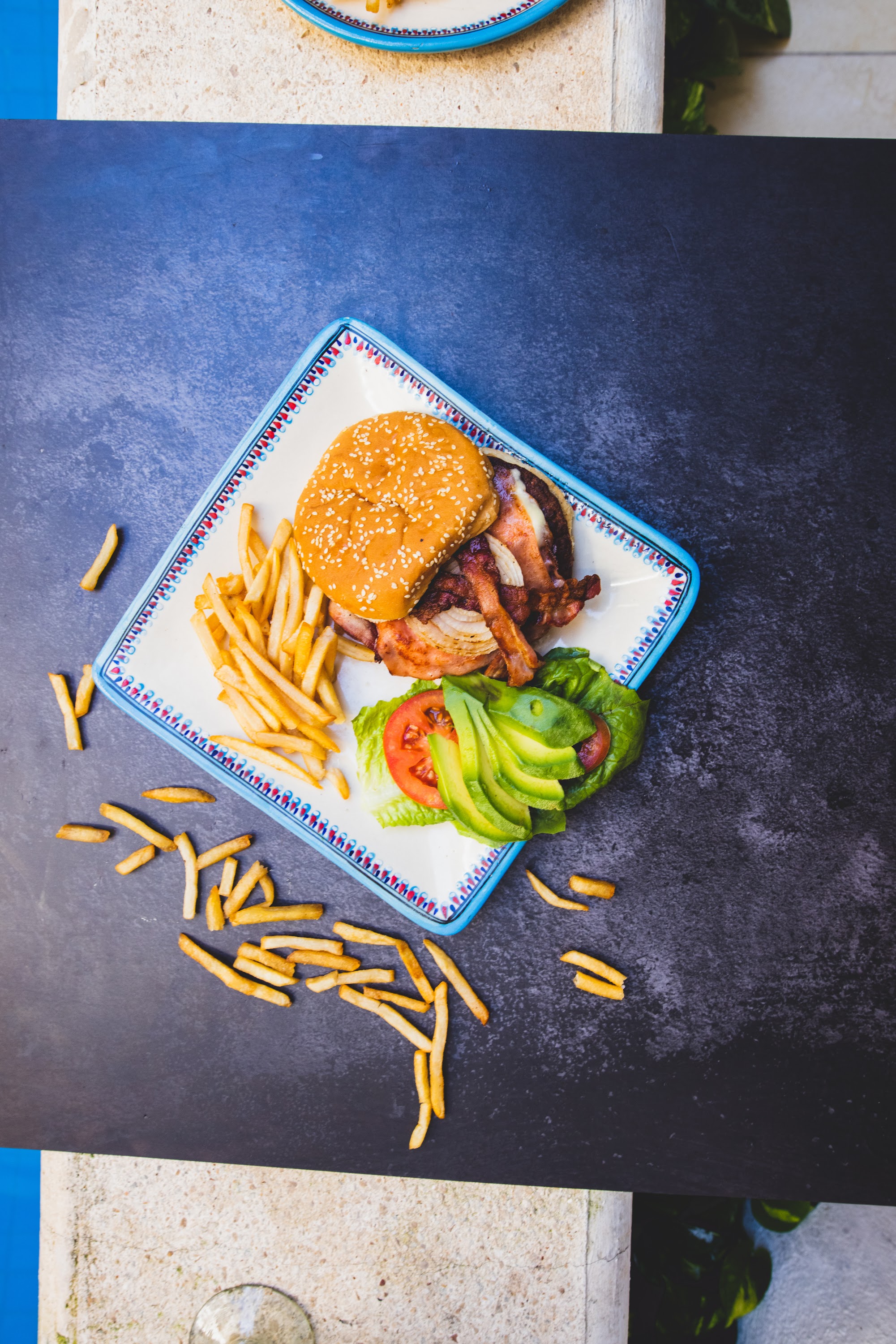 Bacon Avocado Burger with Fries on Decorative Plate