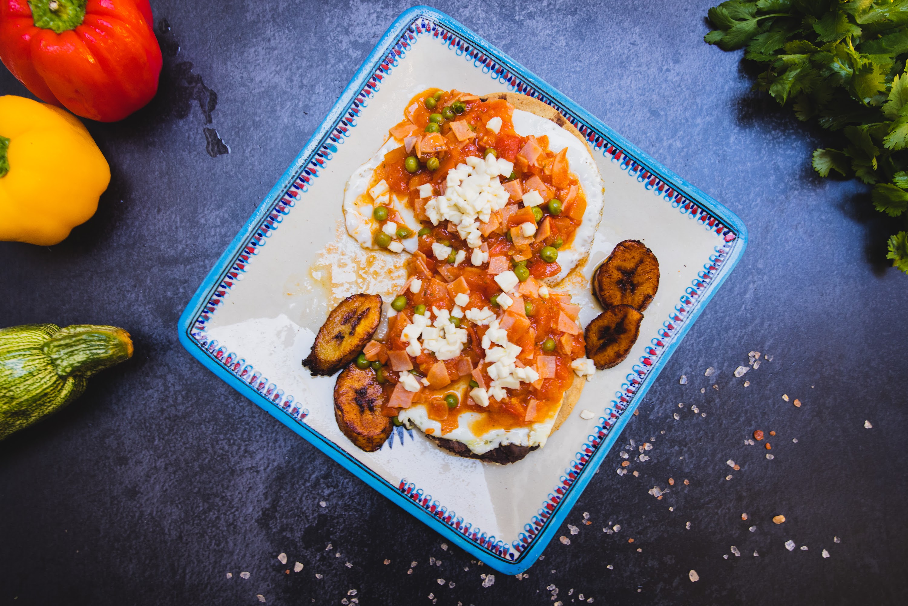 Colorful Mexican-Style Breakfast Plate with Eggs, Plantains, and Fresh Vegetables