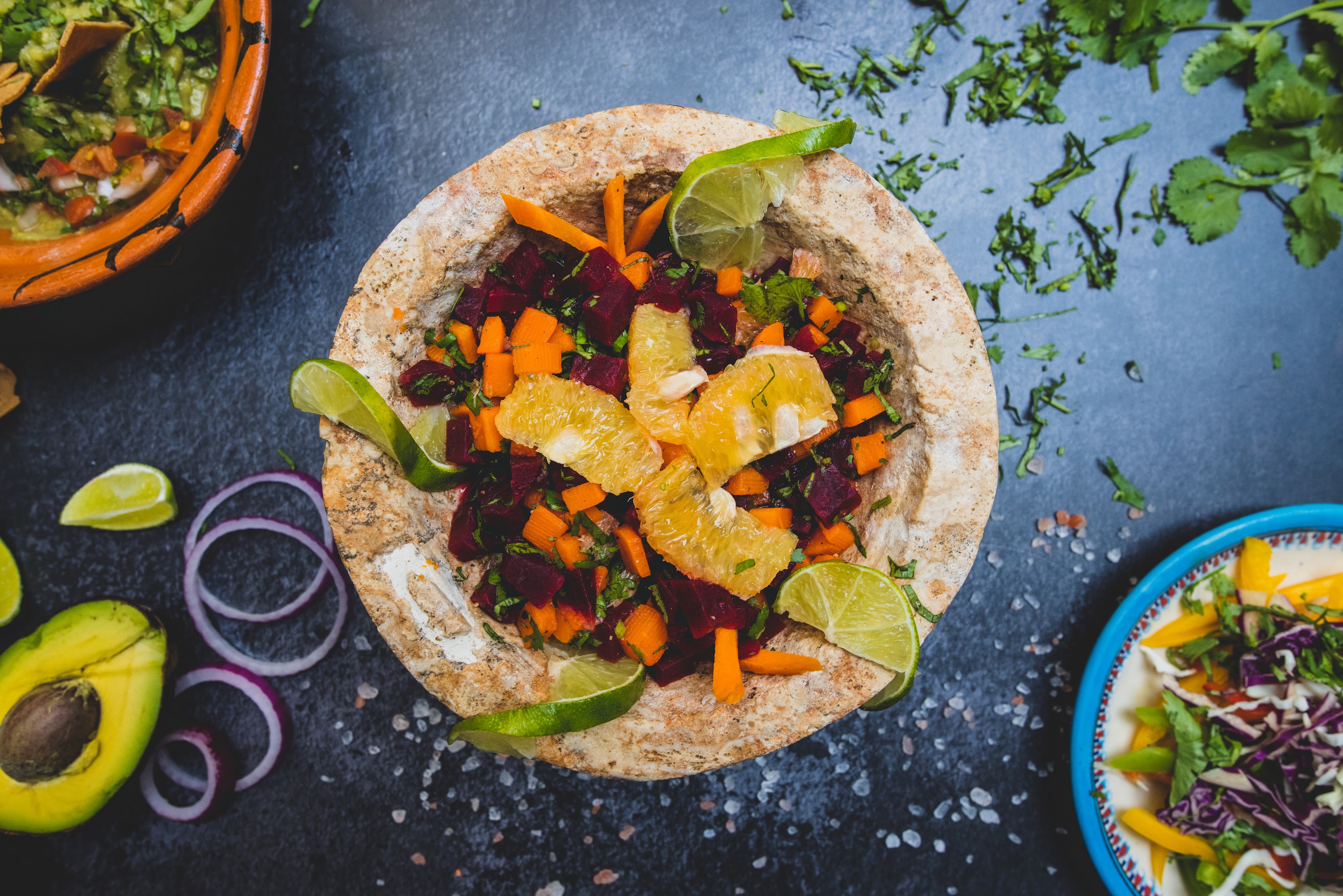 Colorful Beet and Carrot Salad with Citrus in Stone Bowl