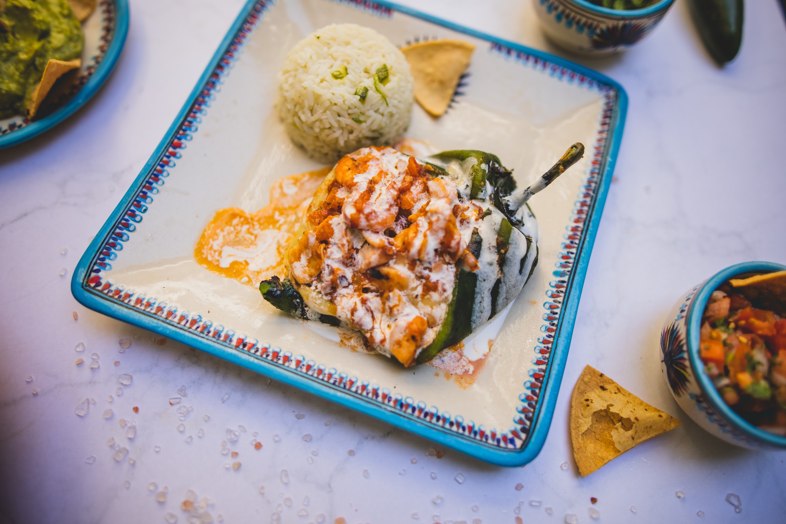 Stuffed poblano pepper with rice and salsa