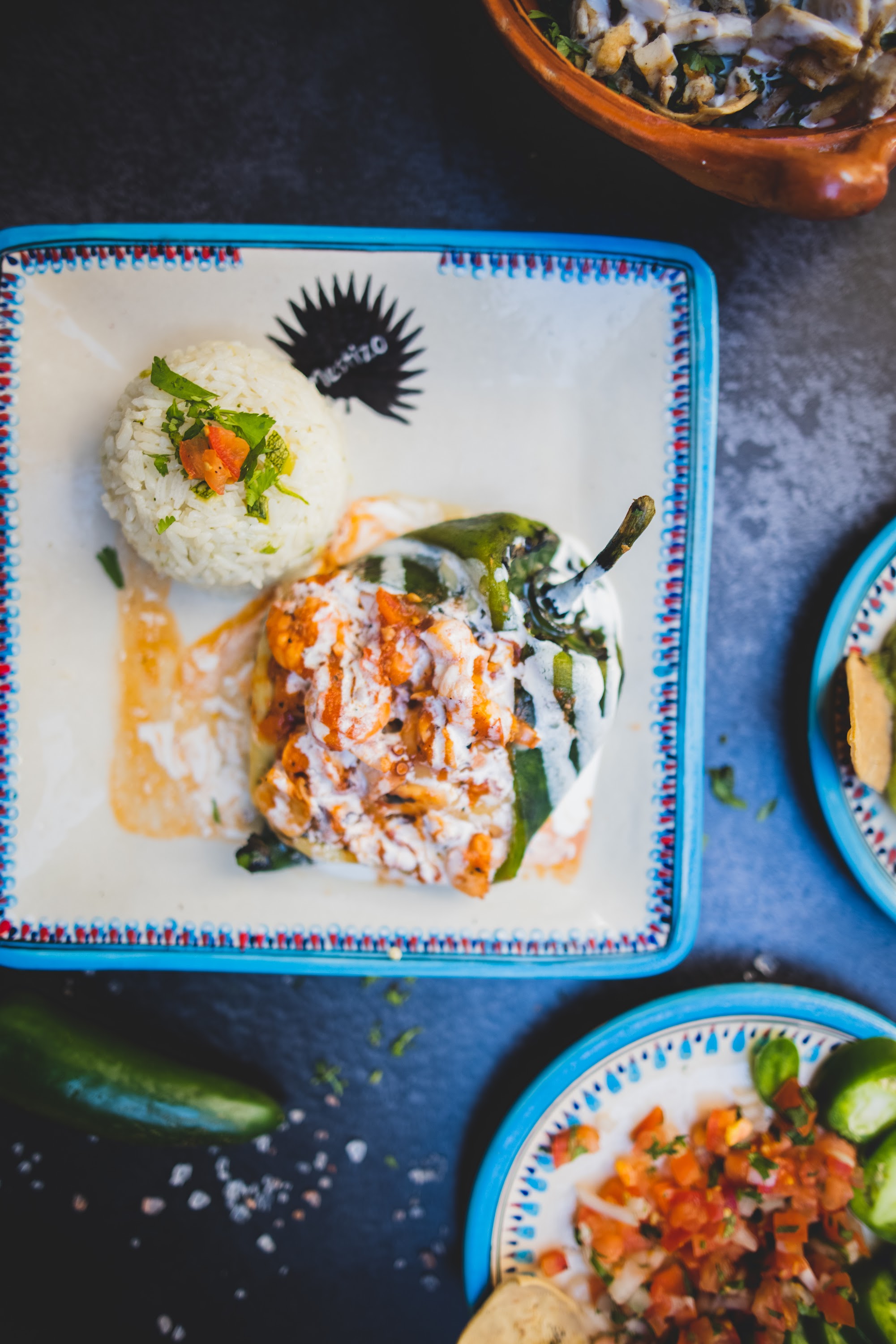 Stuffed poblano pepper with rice and sauce