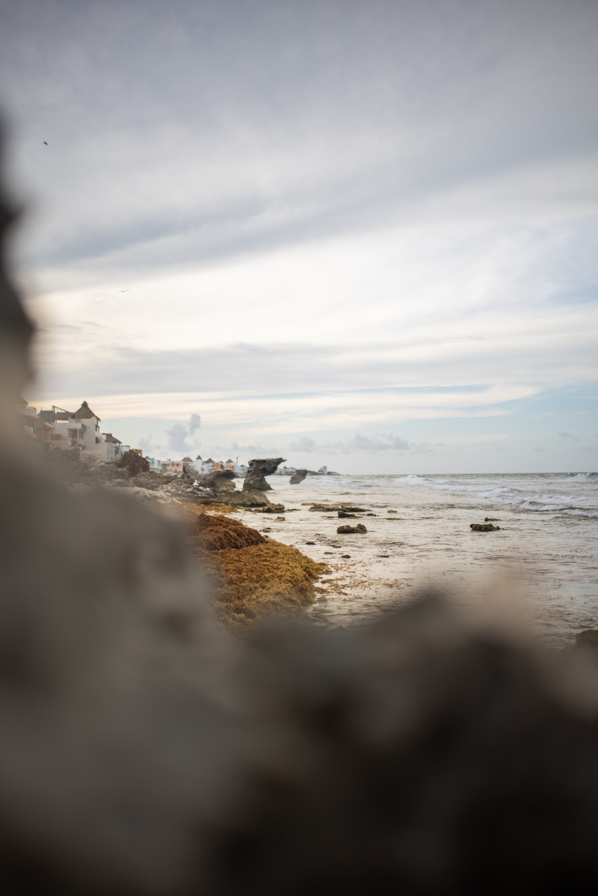 Coastal Village View Through Rock Formation