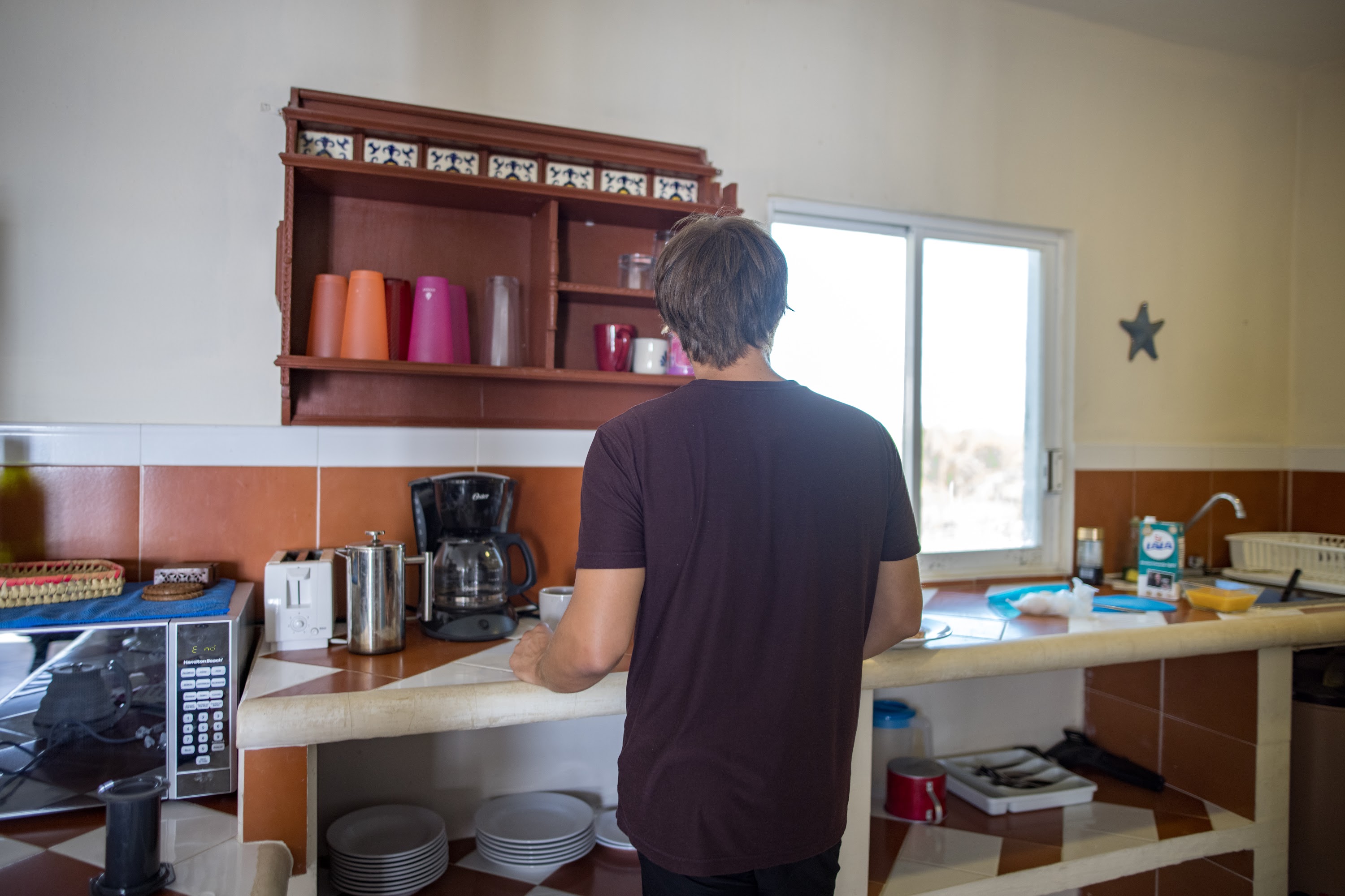 Man Preparing Coffee in Kitchen