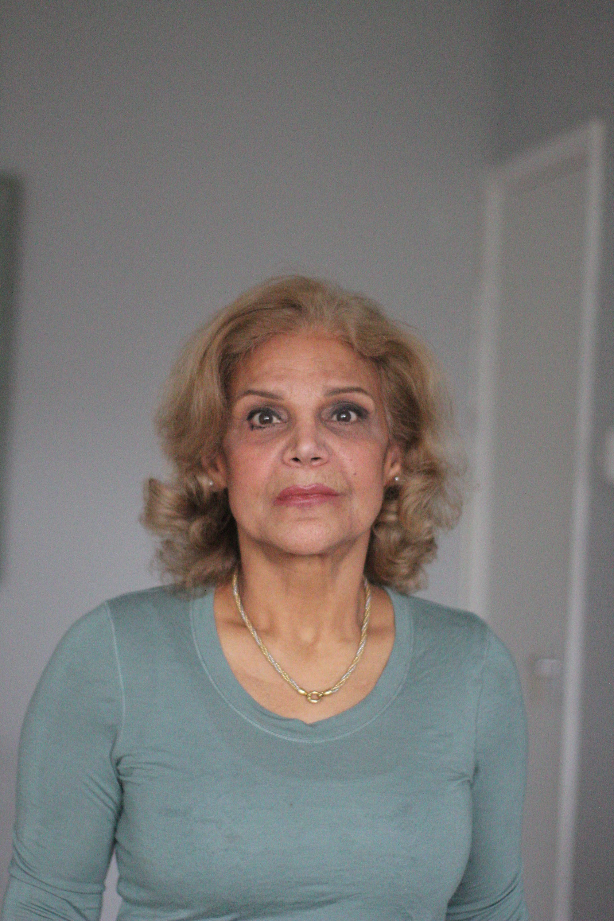 Indoor Portrait of Older Woman in Teal Long-Sleeve Top