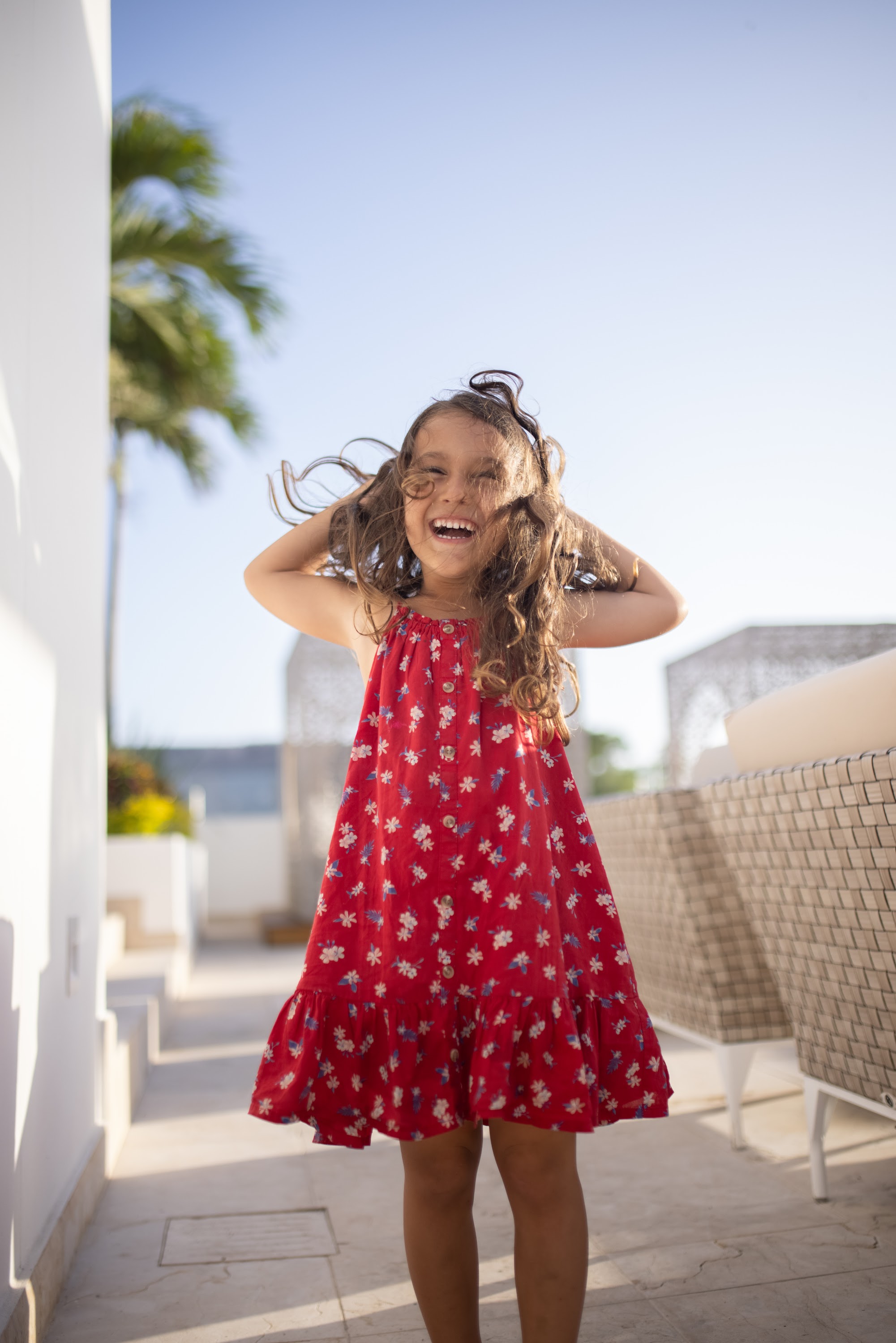 Happy Girl in Red Floral Dress Outdoors