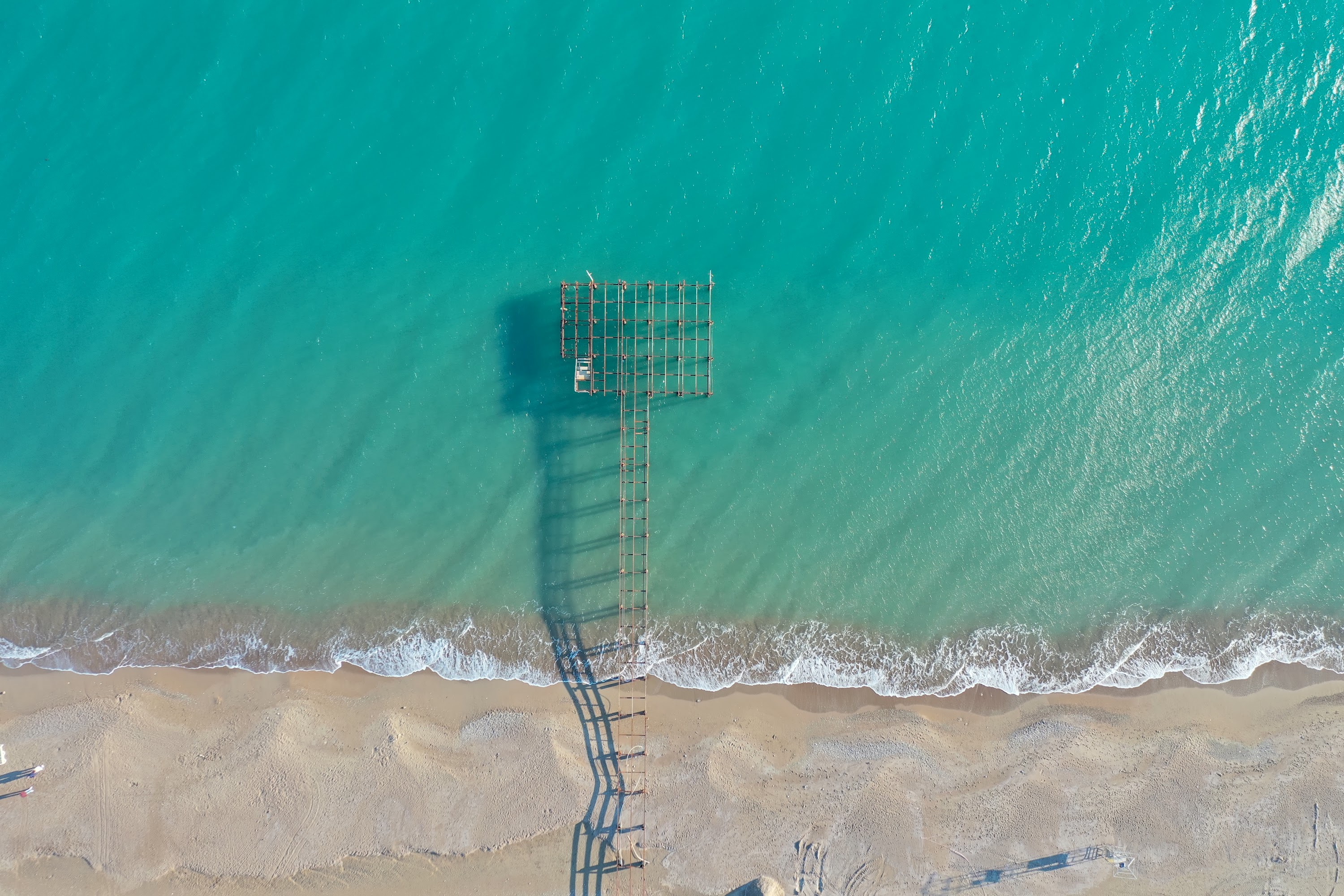 Aerial View of Wooden Pier and T-Platform Extending into Turquoise Sea