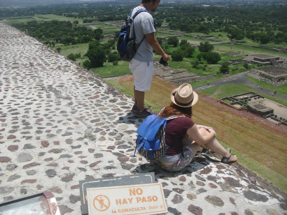 Visitors at the Top of a Mesoamerican Pyramid Overlooking Teotihuacan