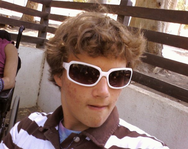 Young Man with Curly Hair Wearing White Sunglasses