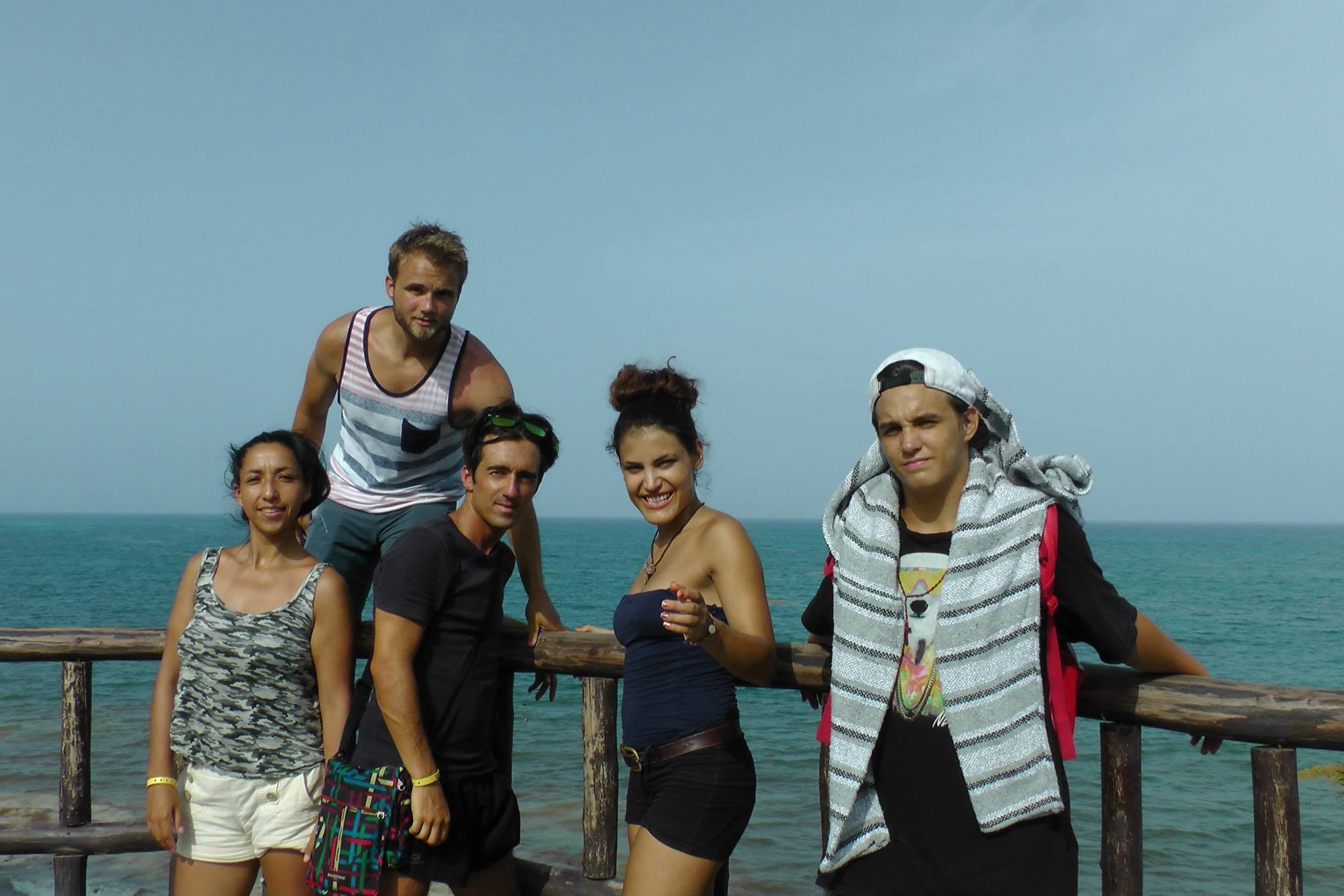 Five friends posing by the ocean