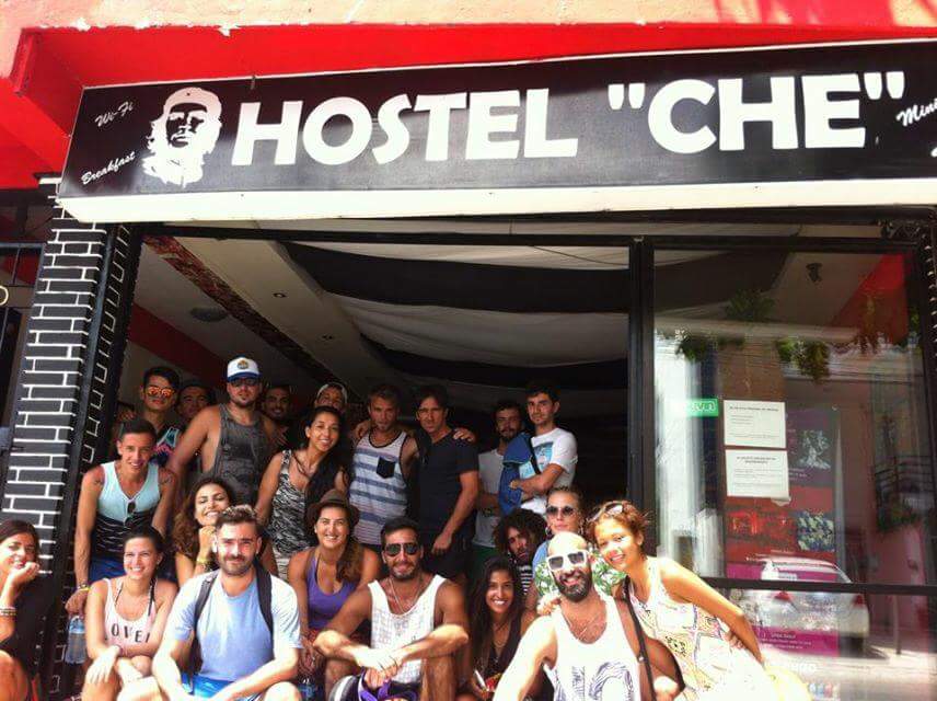 Group of travelers posing in front of Hostel 'Che'