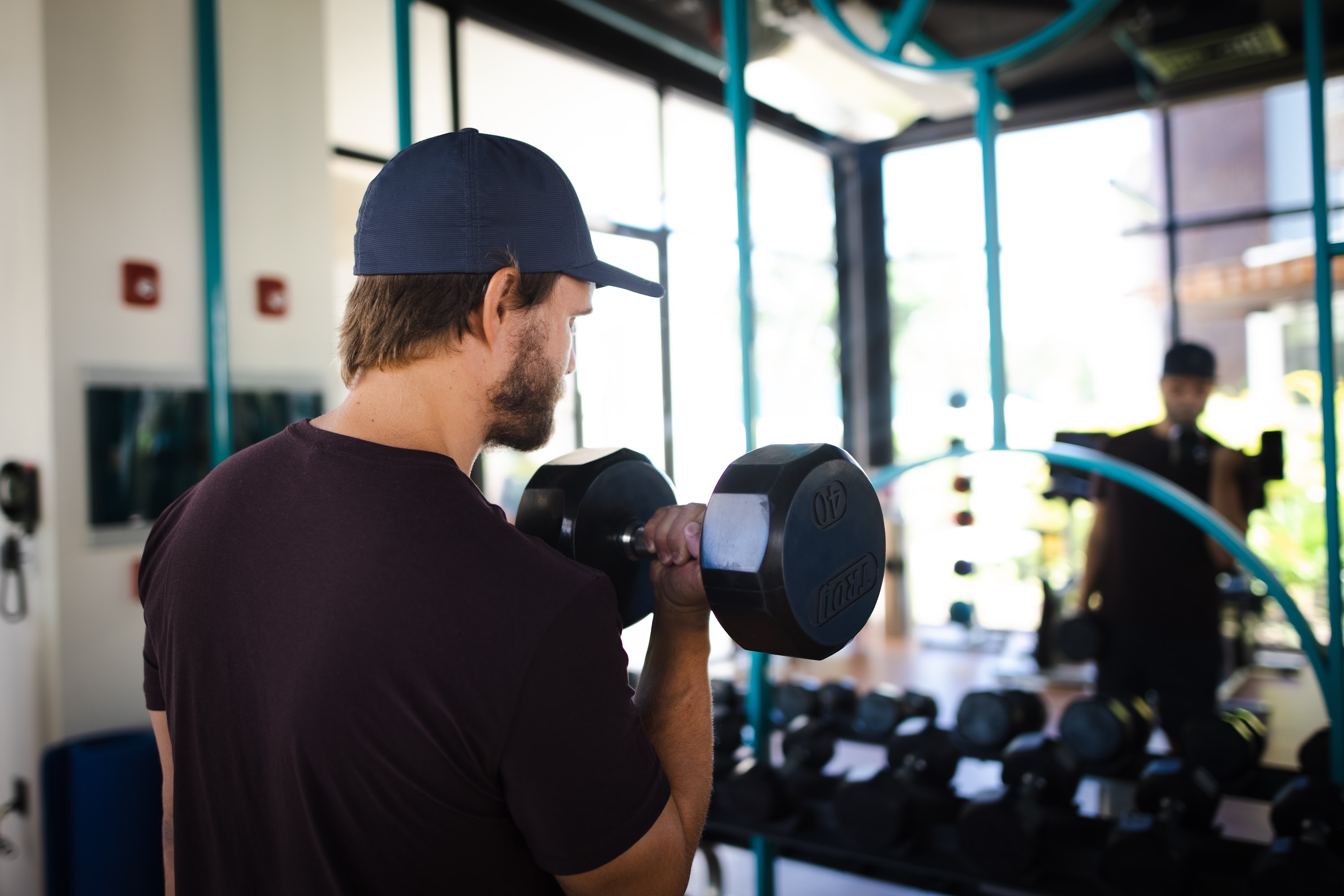Man Lifting Dumbbell in Gym