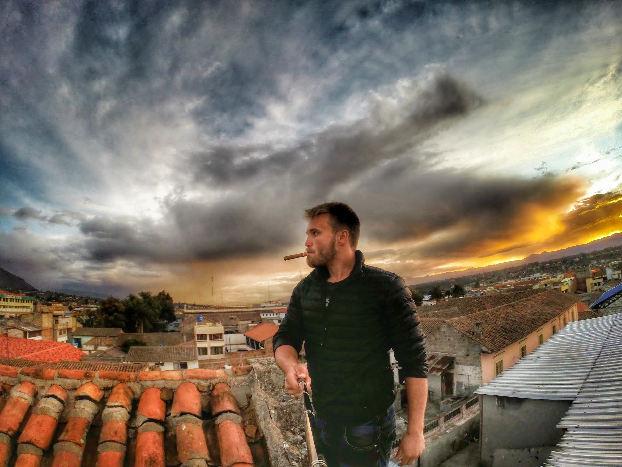 Man on Rooftop with Dramatic Sky