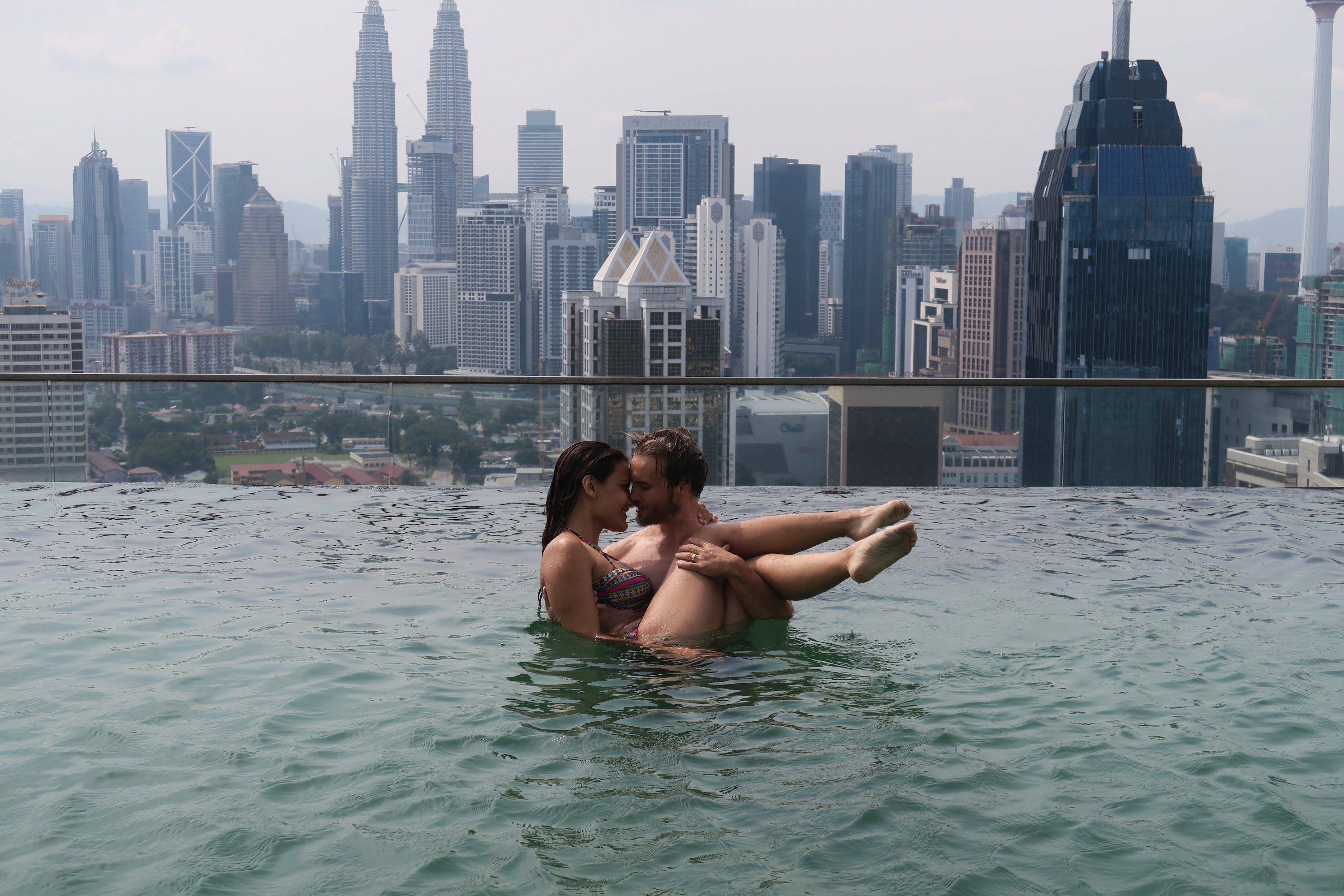 Couple in Infinity Pool with Kuala Lumpur Skyline
