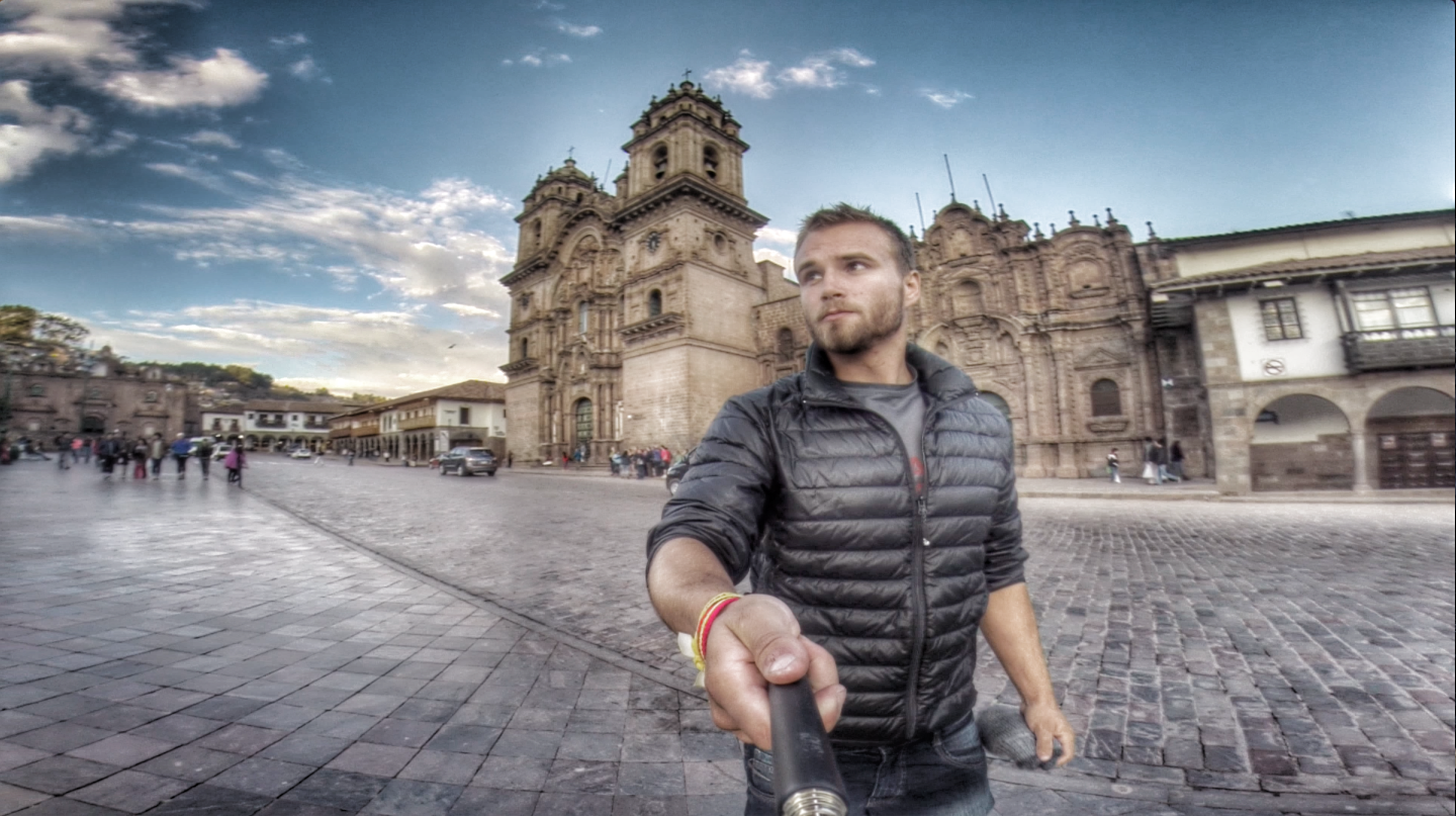 Man Taking Selfie in Historic Plaza with Colonial Church