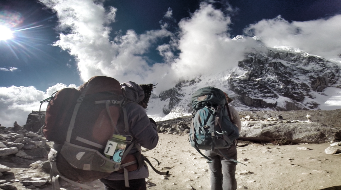 Hikers on a Mountain Trail with Snow-Capped Peaks