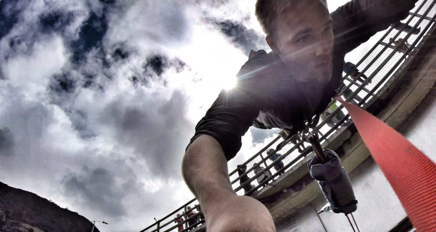 Man on a Zipline with Cloudy Sky Background