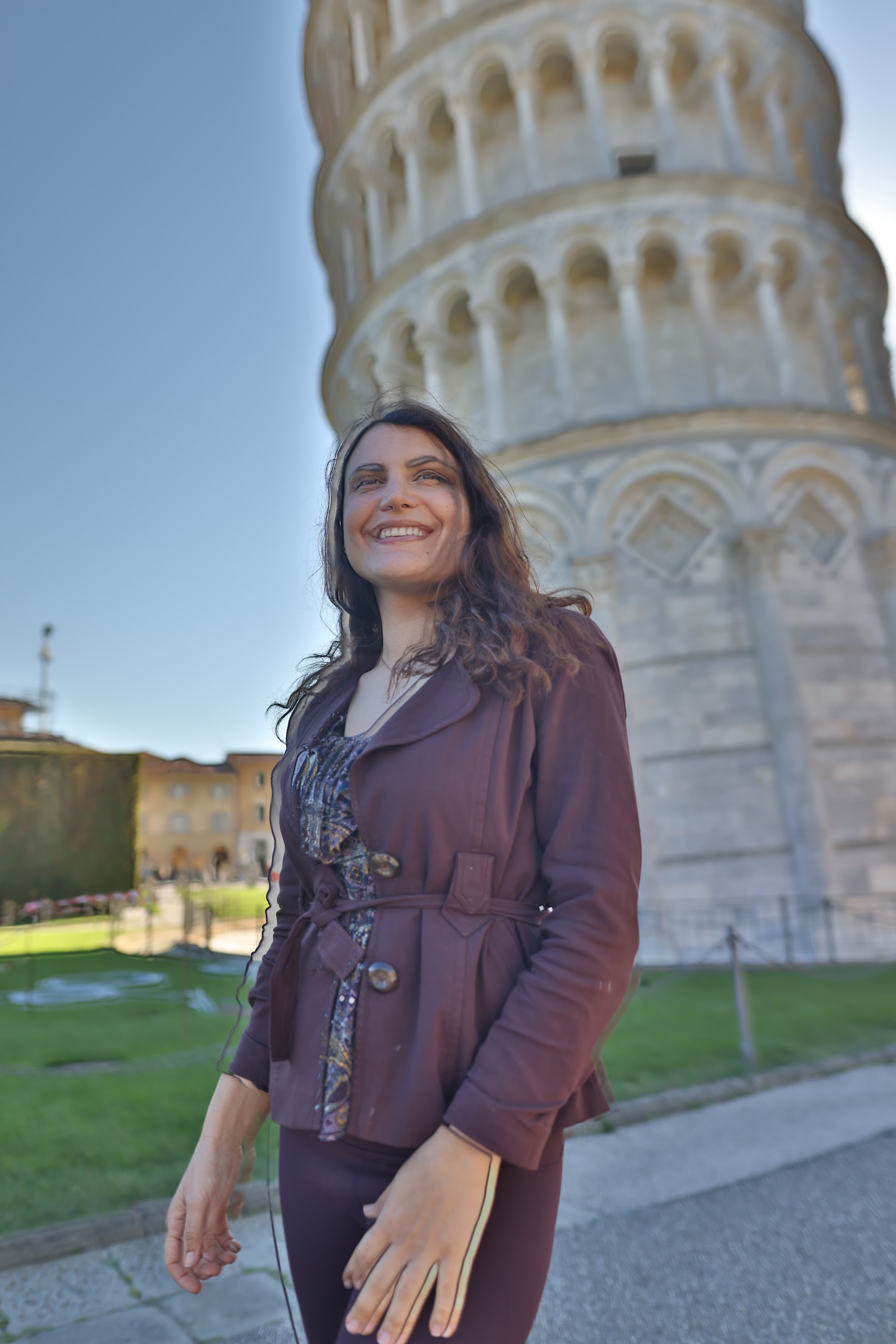 Woman Smiling in Front of the Leaning Tower of Pisa