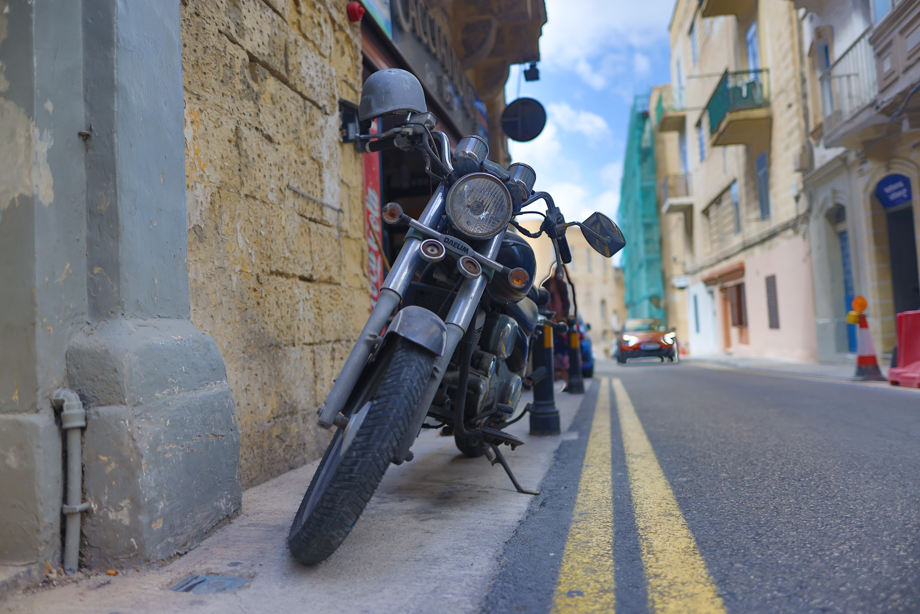Vintage Motorcycle Parked on a Narrow Street