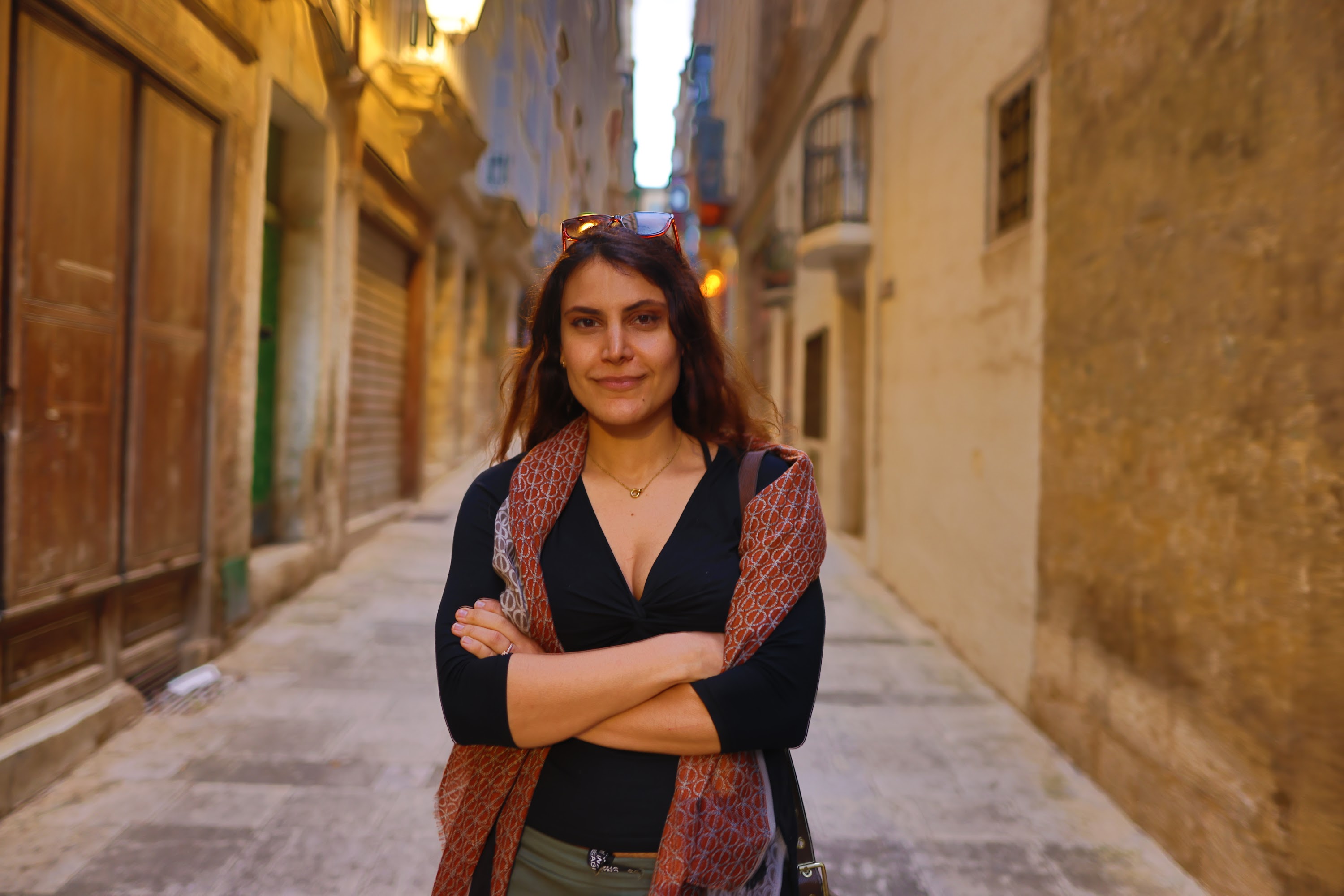 Woman Standing in Historic Alleyway