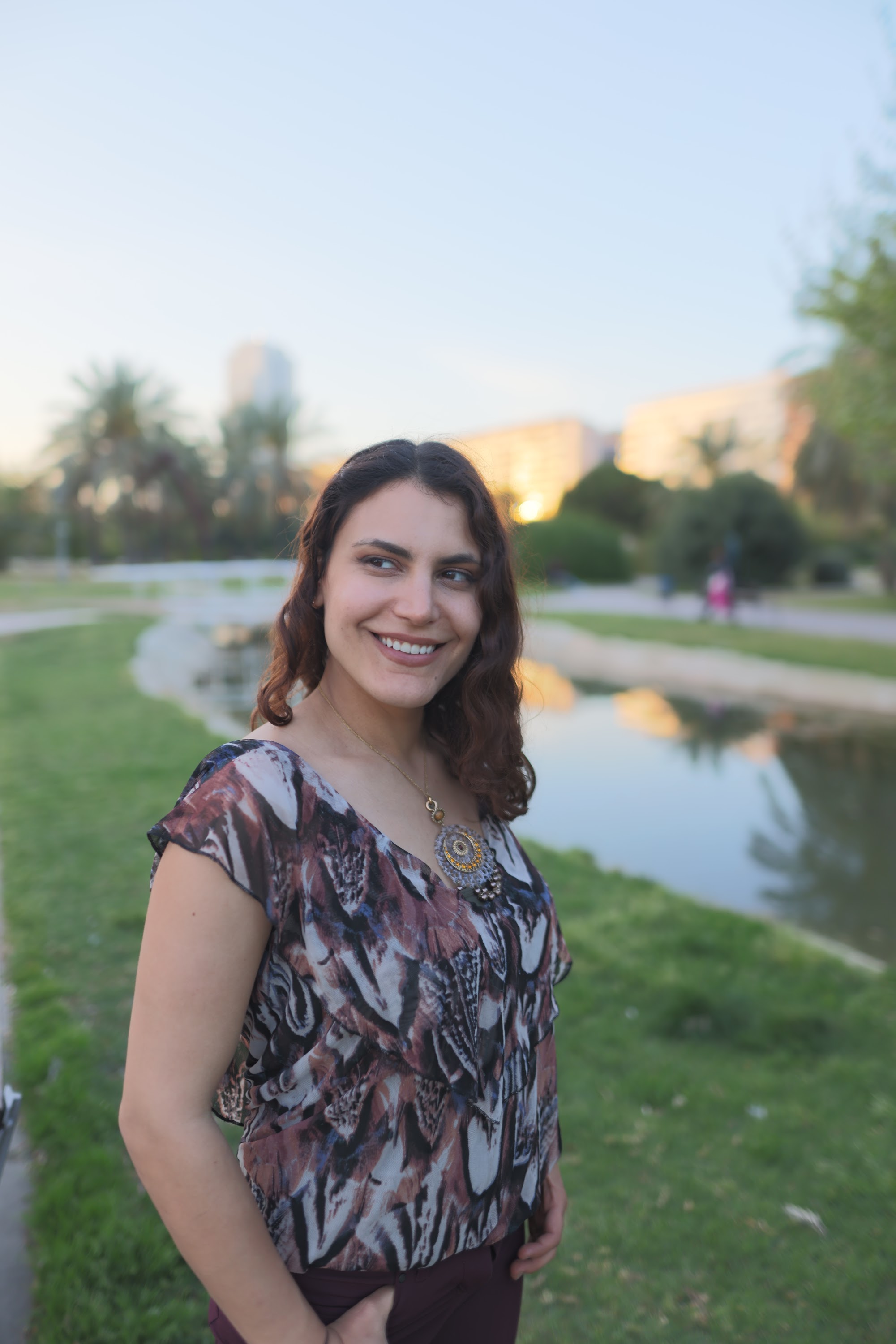 Smiling Woman in Park at Dusk