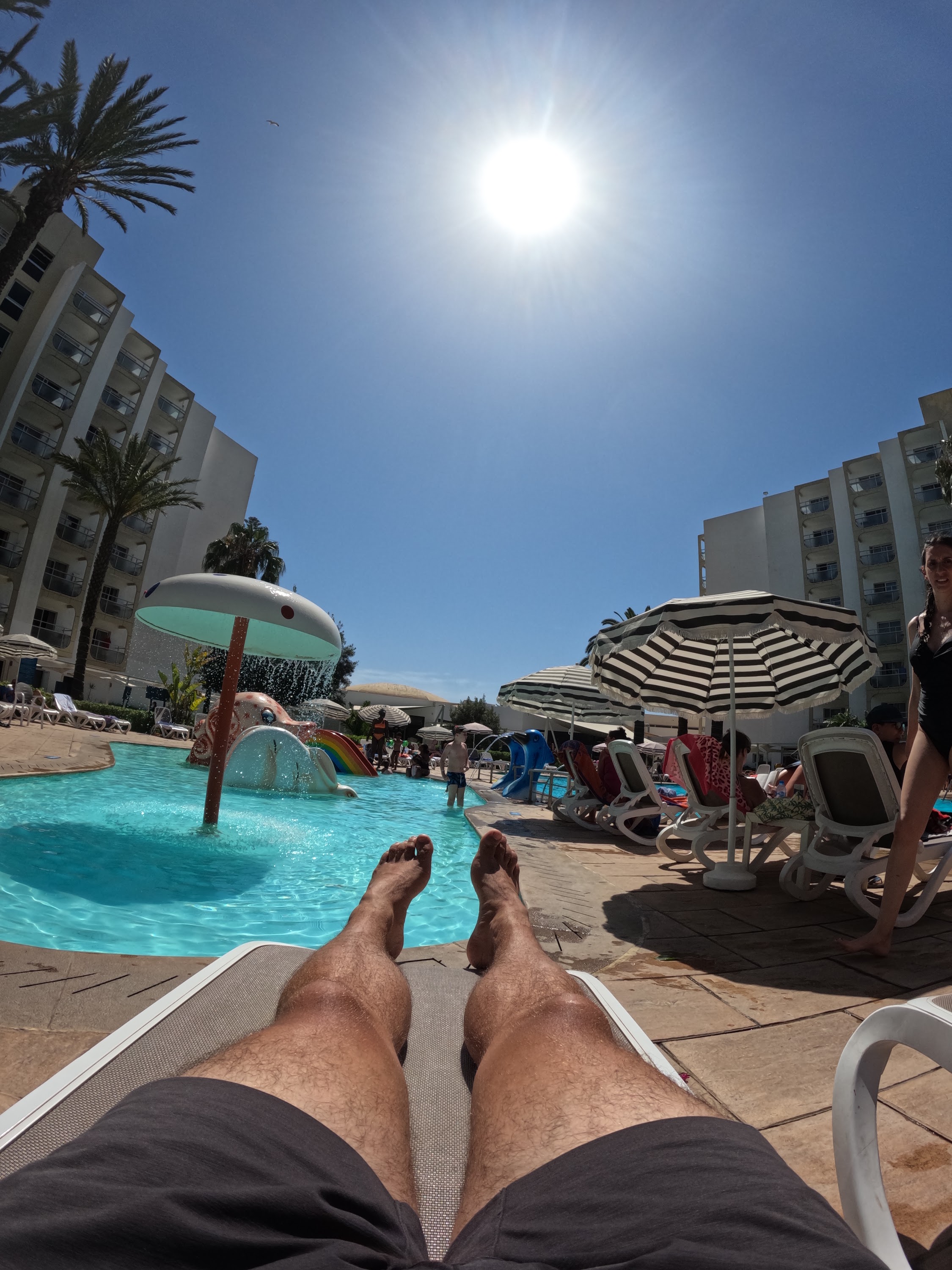 Poolside Relaxation Under Bright Sunlight