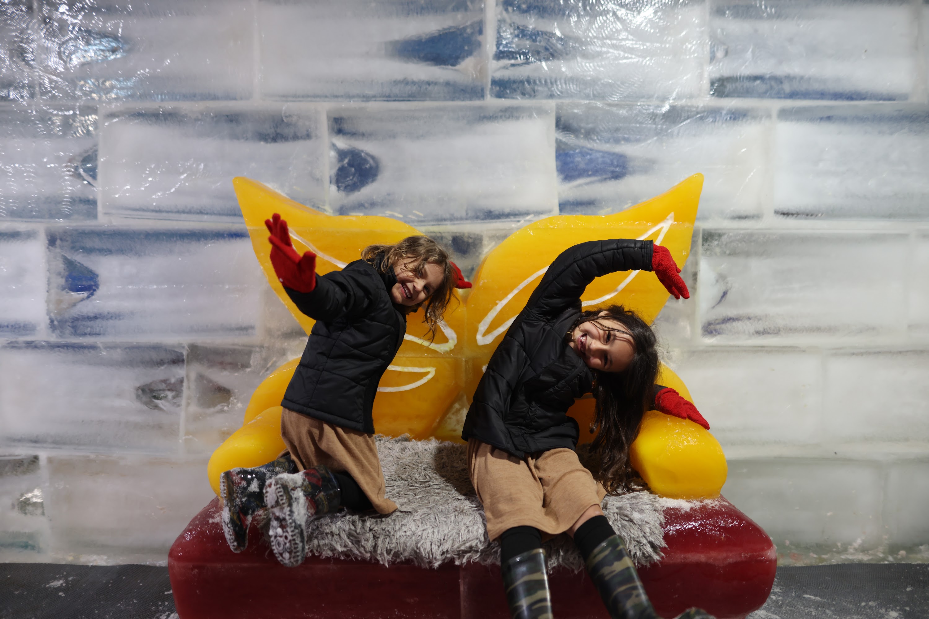 Two Children Playing on Ice Sculpture