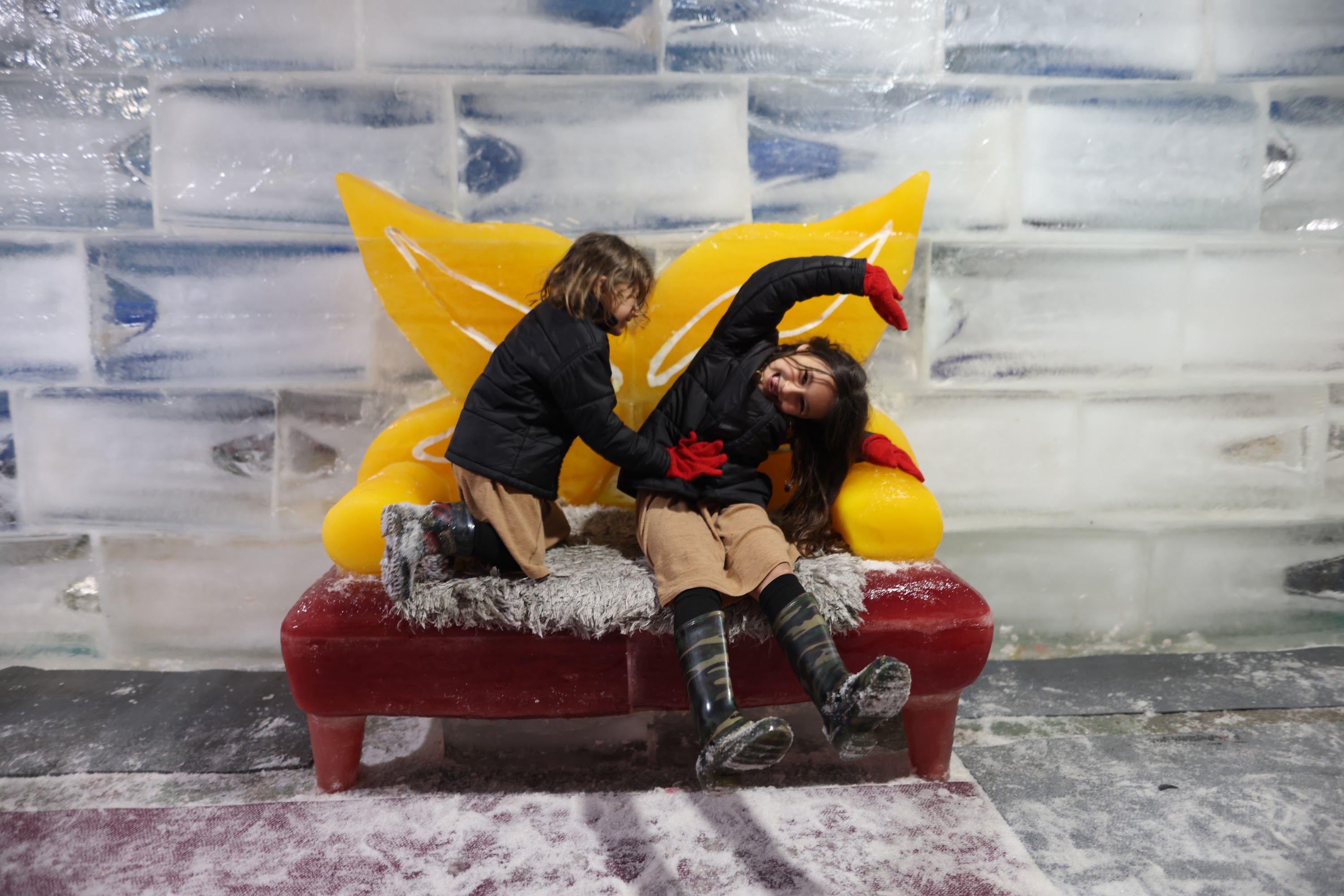 Children Playing on Ice Sculpture Bench
