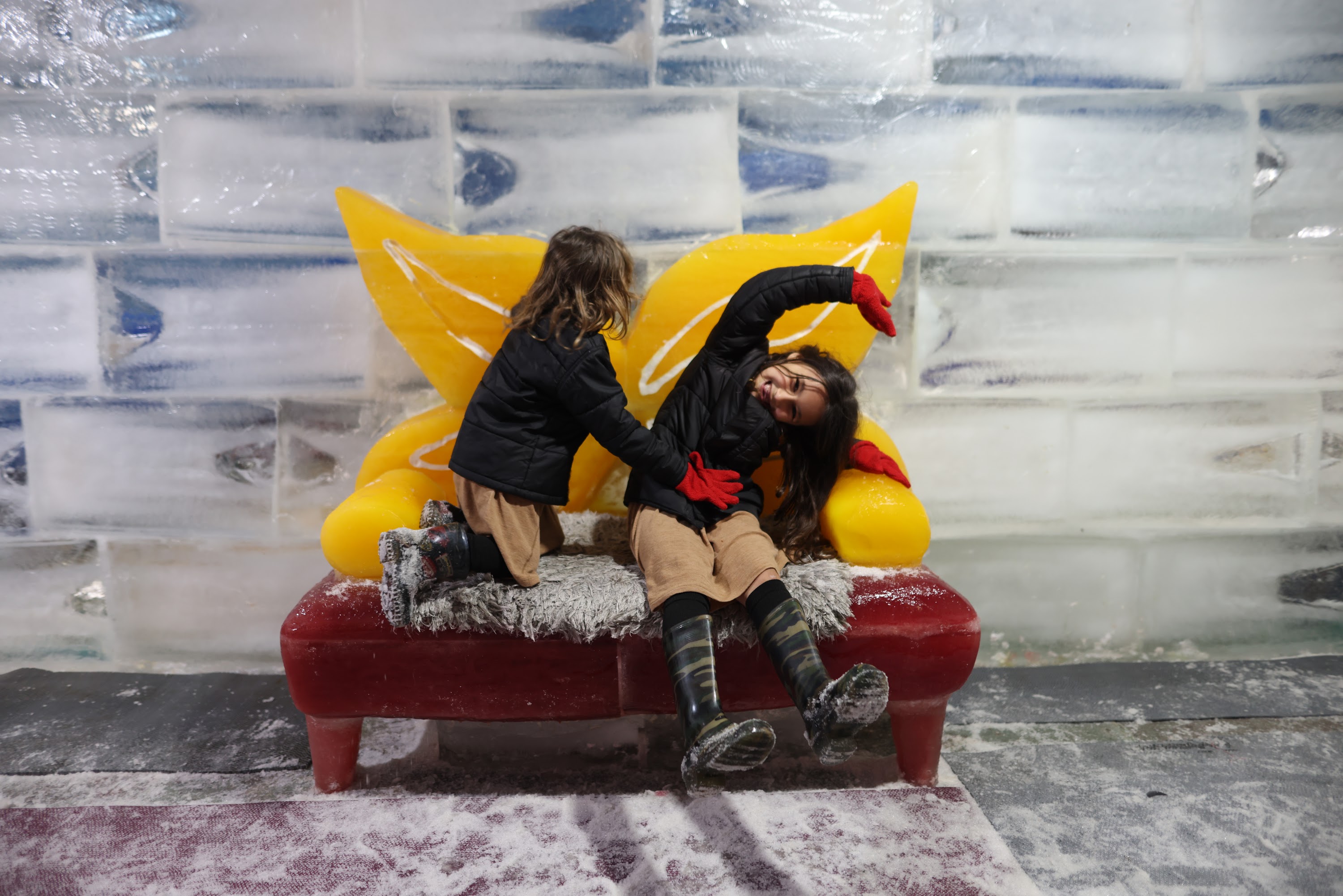 Children Playing on Colorful Ice Sculpture Bench
