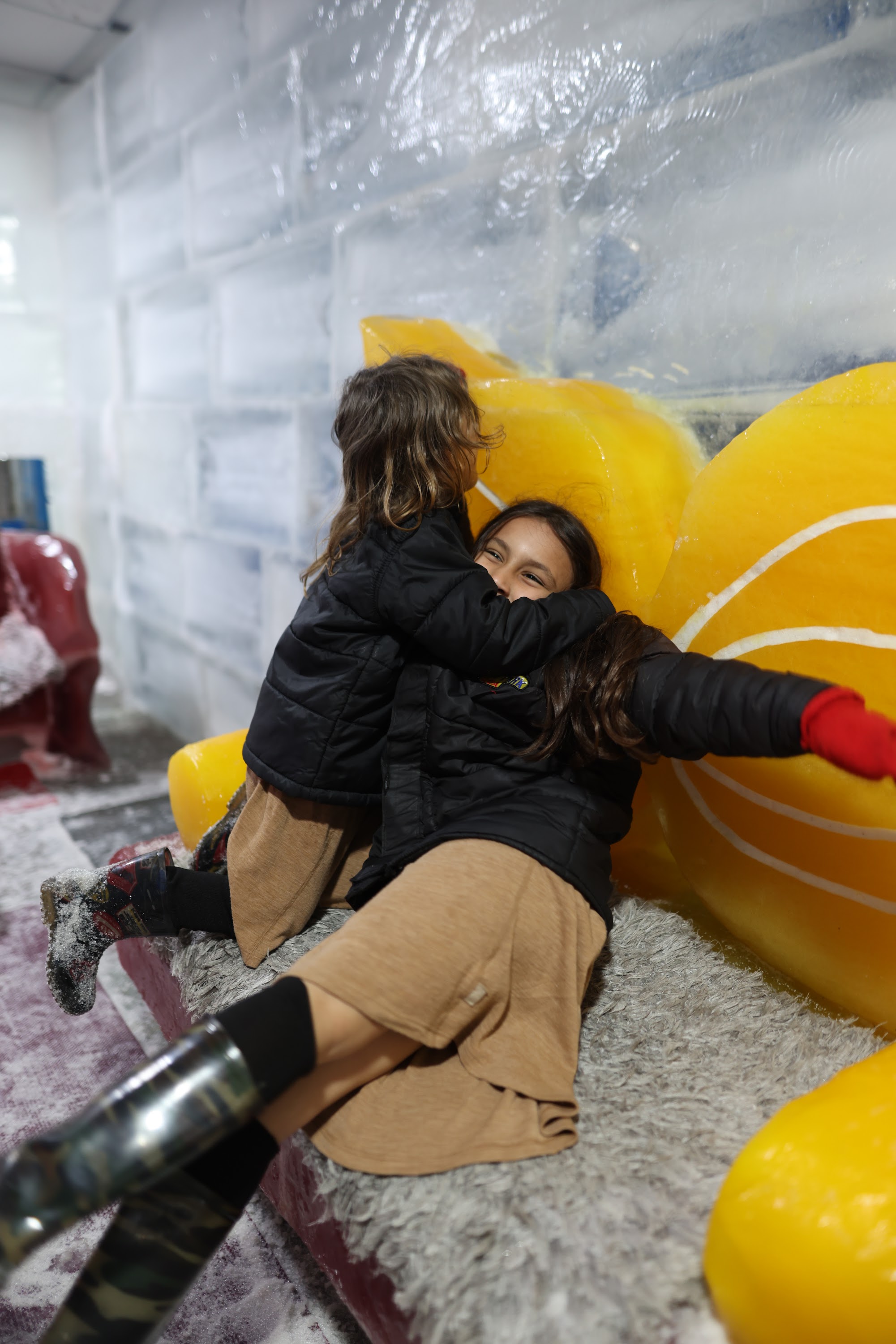 Two Girls Playing at an Indoor Ice Experience Attraction