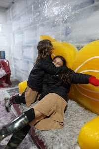 Two Girls Playing at an Indoor Ice Experience Attraction